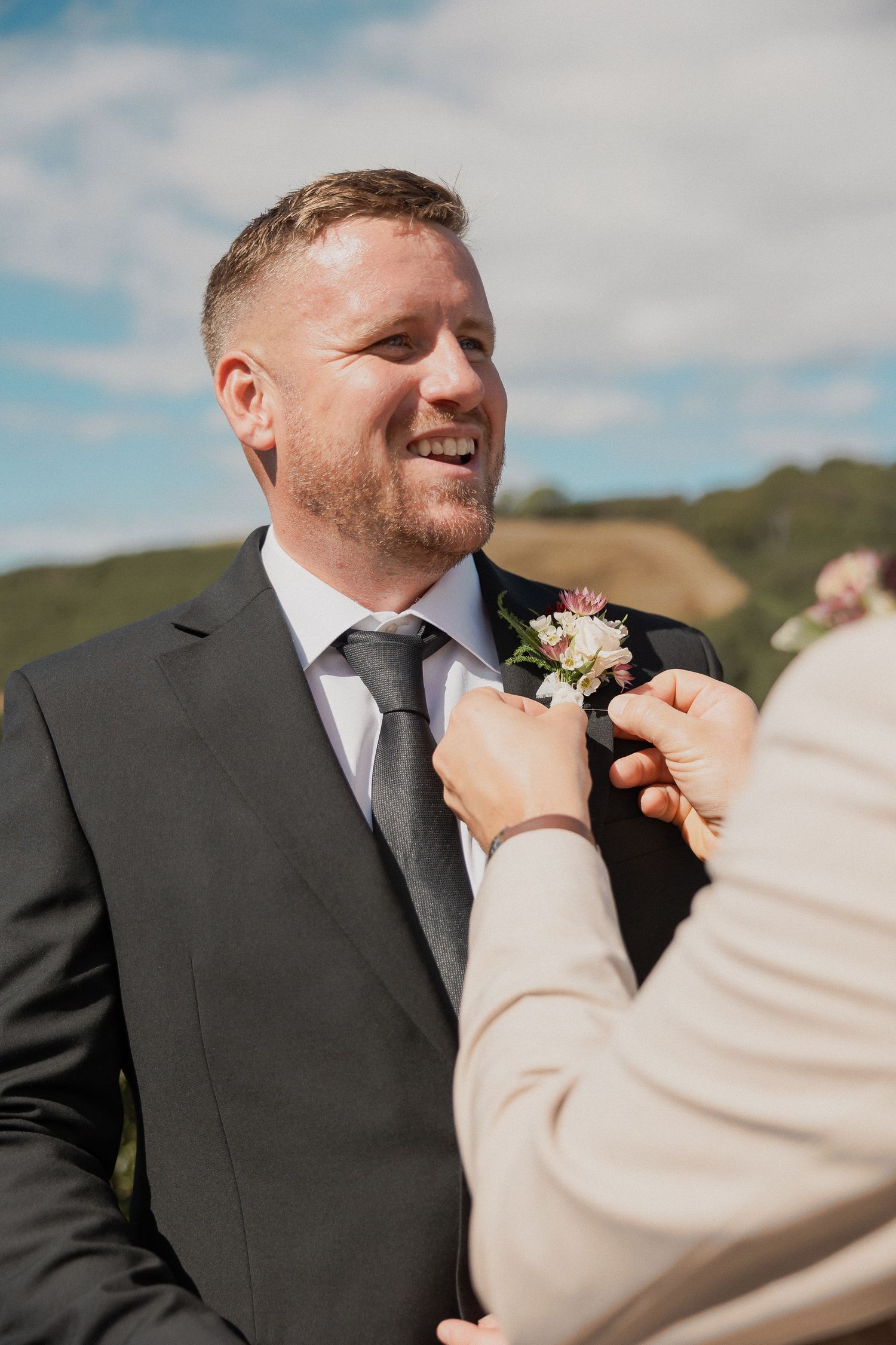 Best Man adjusting Groom buttonhole before the ceremony