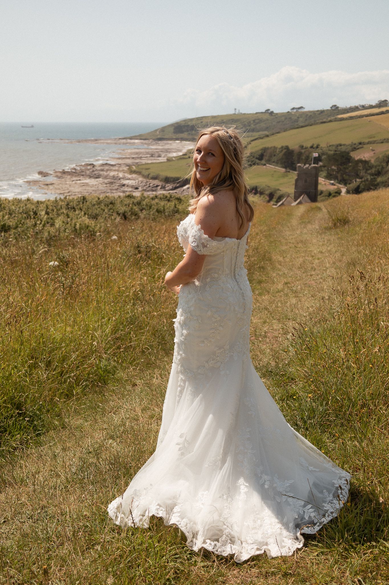 Bridal portrait of bride standing on the cliffs at Wembury, South Devon