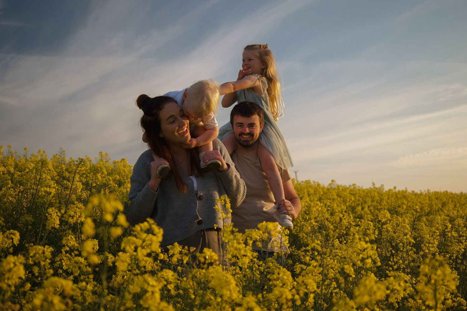 Family playing in rapeseed fields during family shoot in South Devon