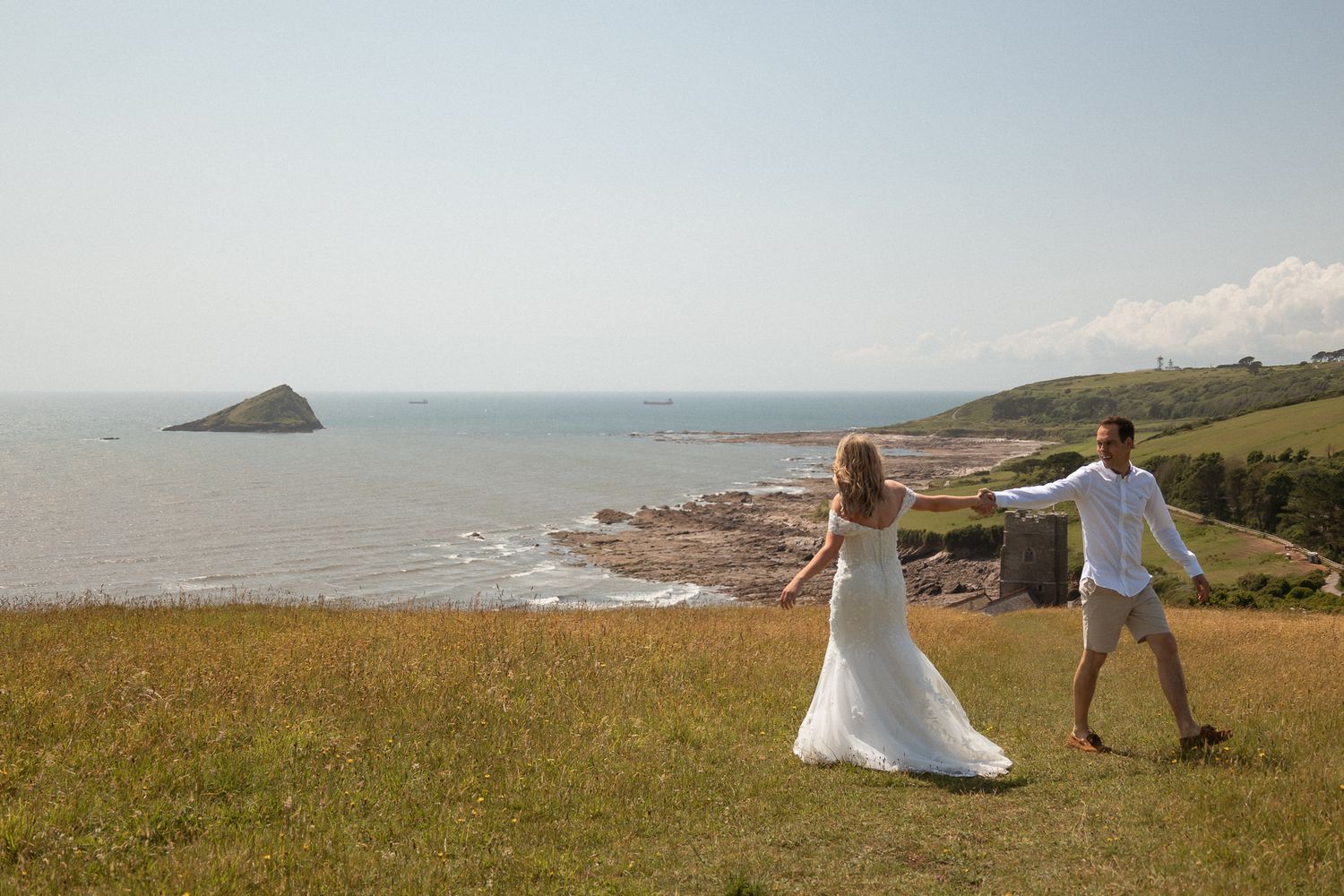 Bride and Groom dancing on cliff top overlooking Wembury beach in South Devon