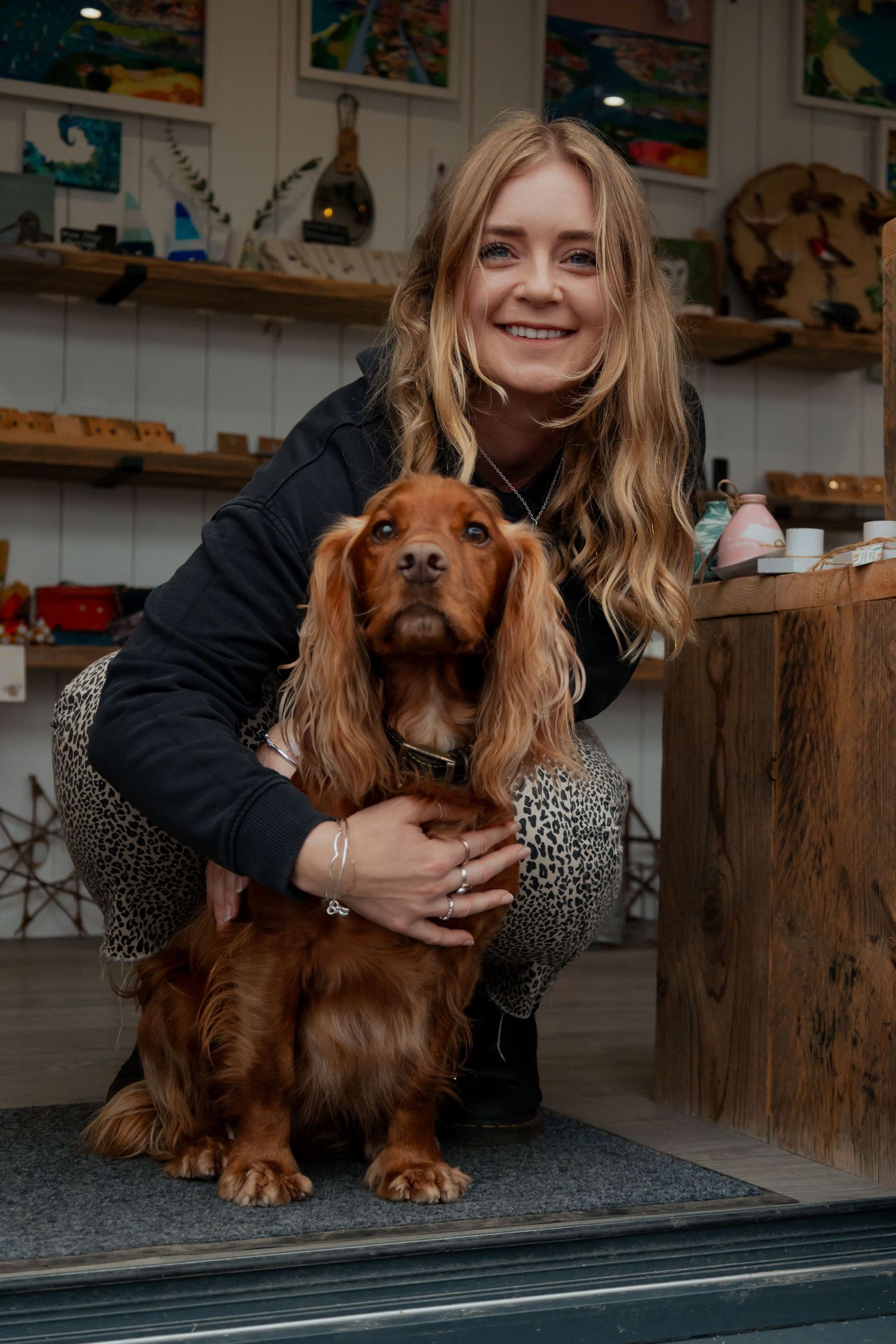 Natural headshot of South Devon art gallery business owner in outdoor setting with her dog