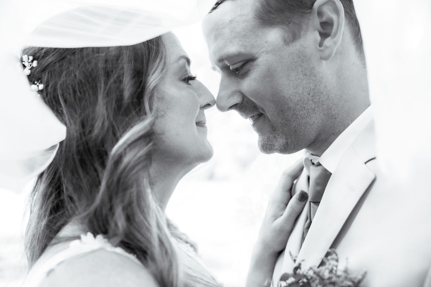 A romantic black and white photo collage shows tender moments between a couple on their wedding day.