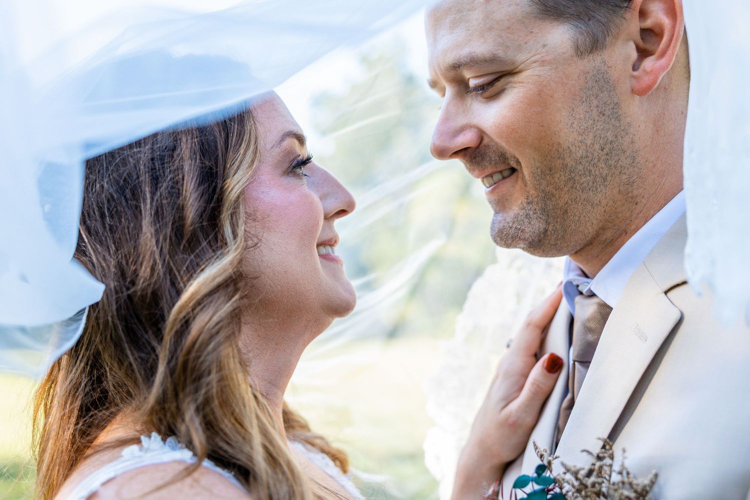A happy couple shares romantic moments together in a scenic mountain landscape during their engagement photoshoot.