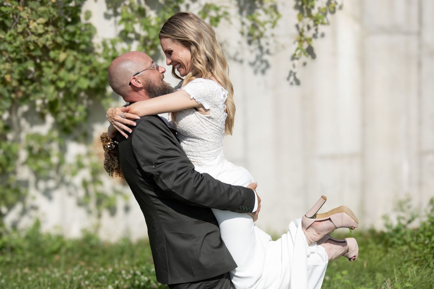 A series of romantic wedding photos showing a couple embracing and dancing outdoors in formal attire.