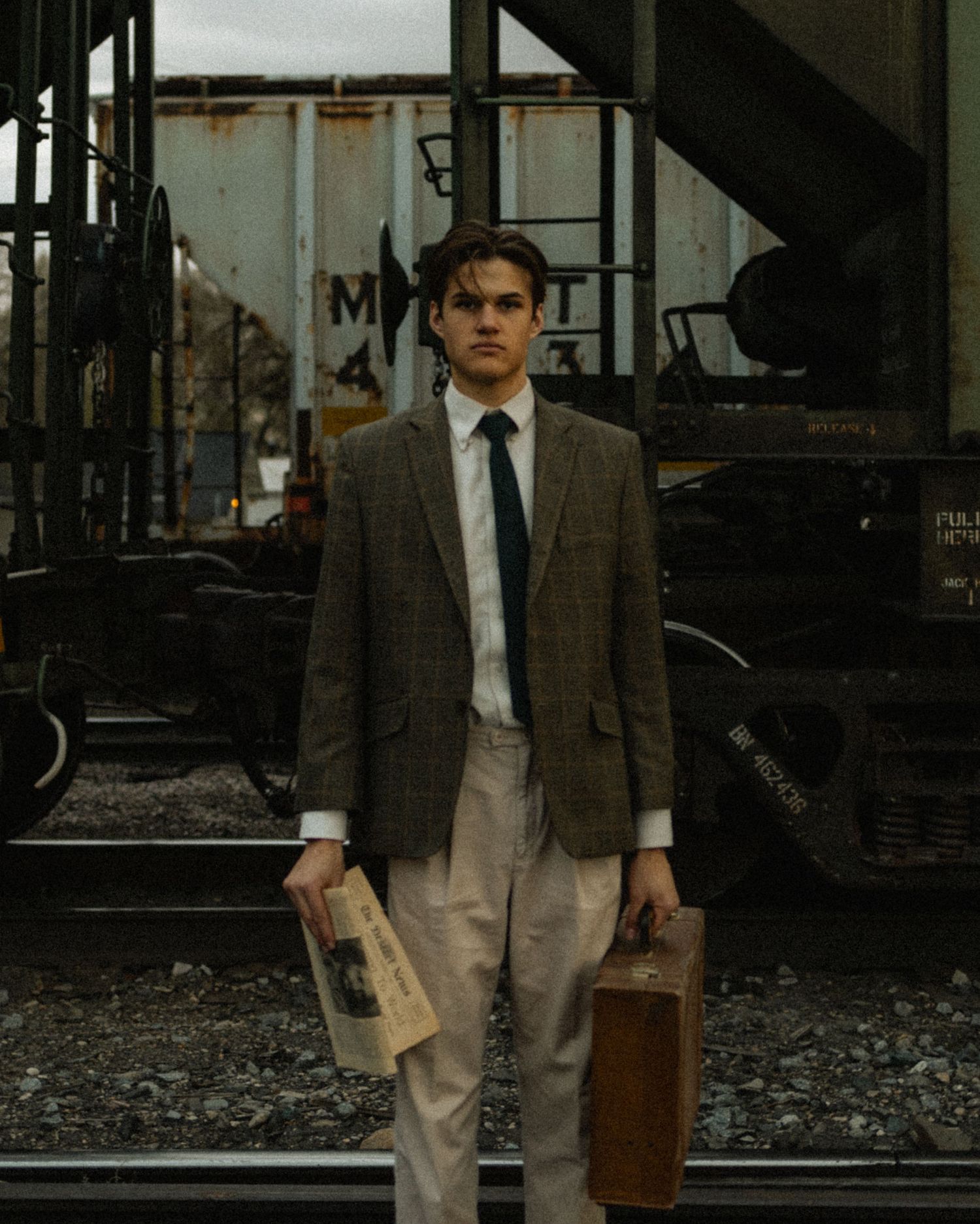 a cinematic filmy senior photos of a man running late for a train