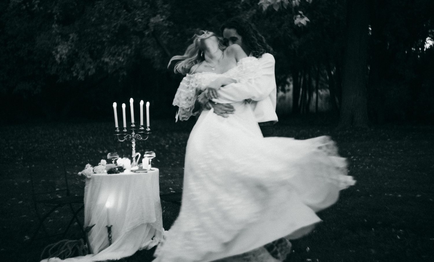 a filmic cinematic black and white photo of an elopement dinner between a bride and groom