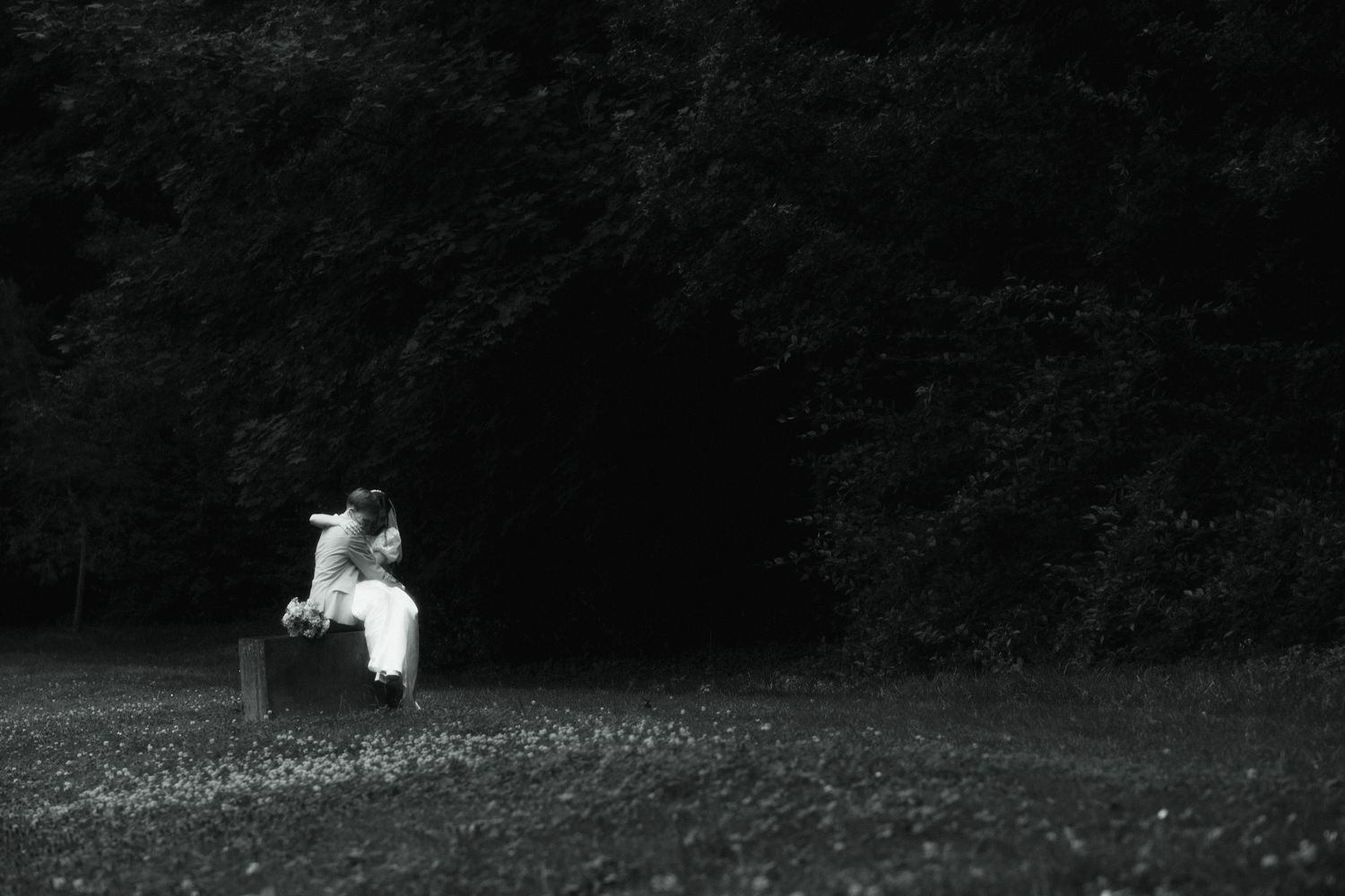 a cinematic quiet moment between lovers in a moment between the crazy wedding day planning in a small clearing surrounded by magical trees