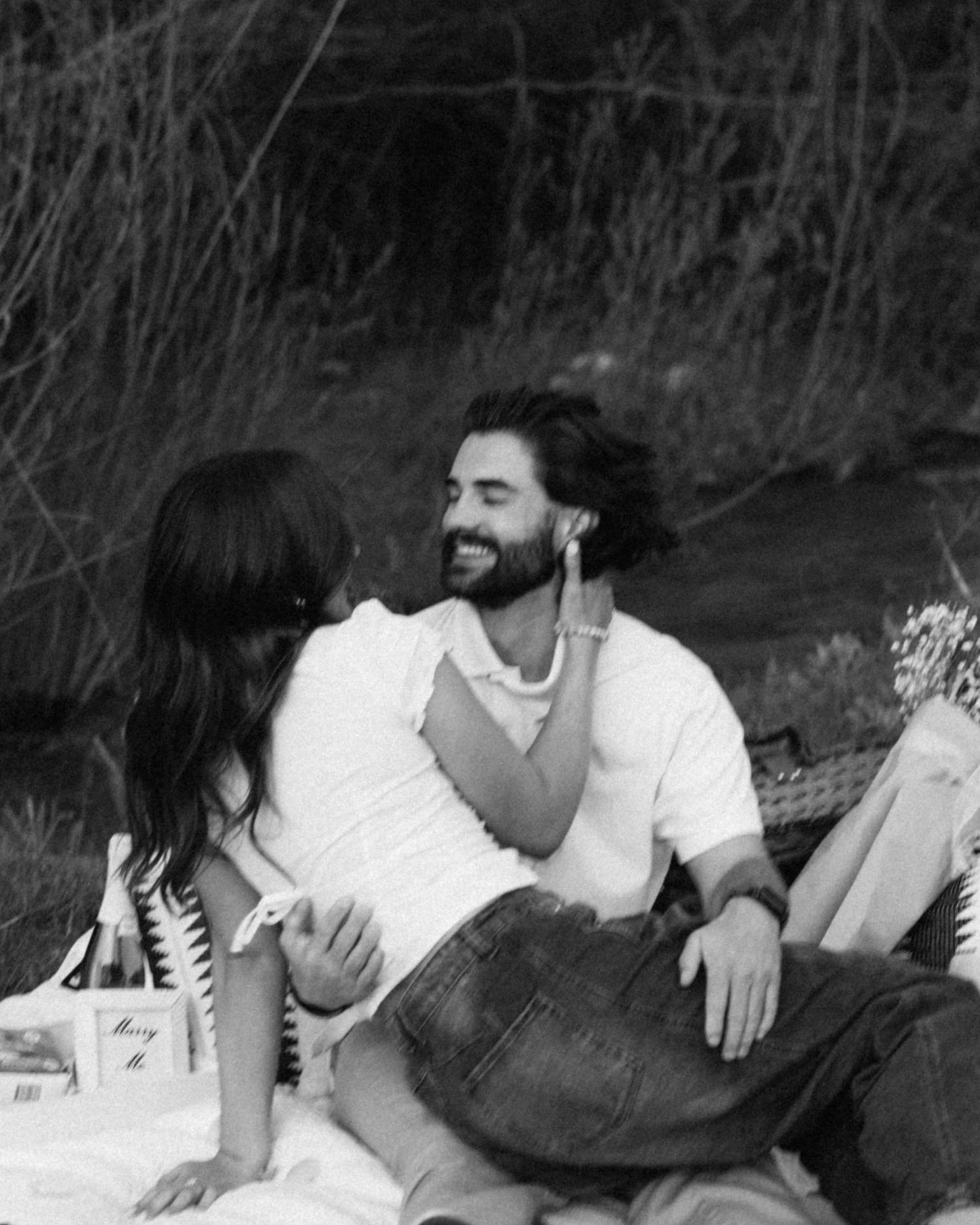 a black and white filmy photo of a couple smiling after their engagement in the Idaho mountains