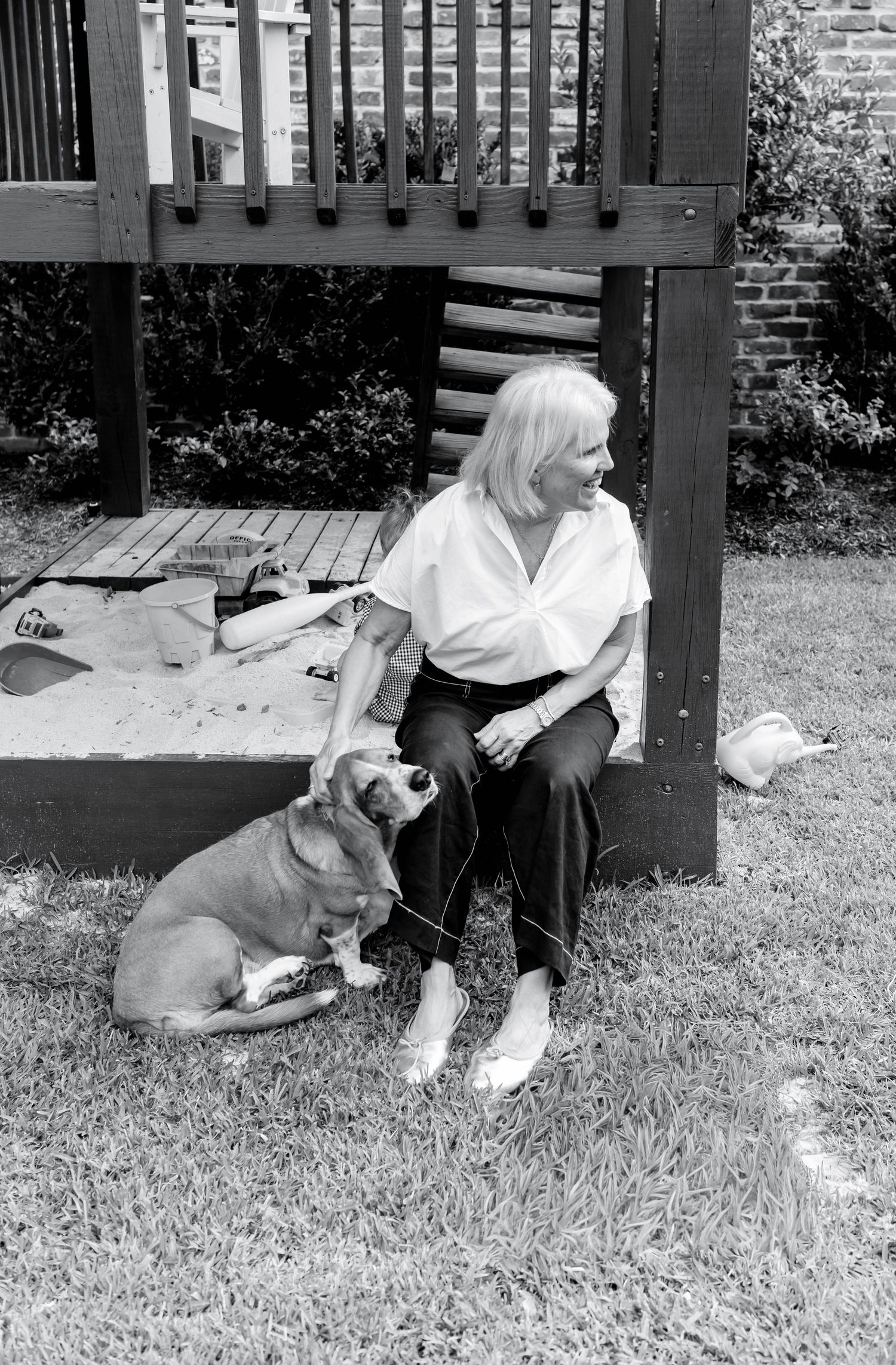 Black and white photo series showing a person relaxing outdoors with a friendly beagle dog on the grass.