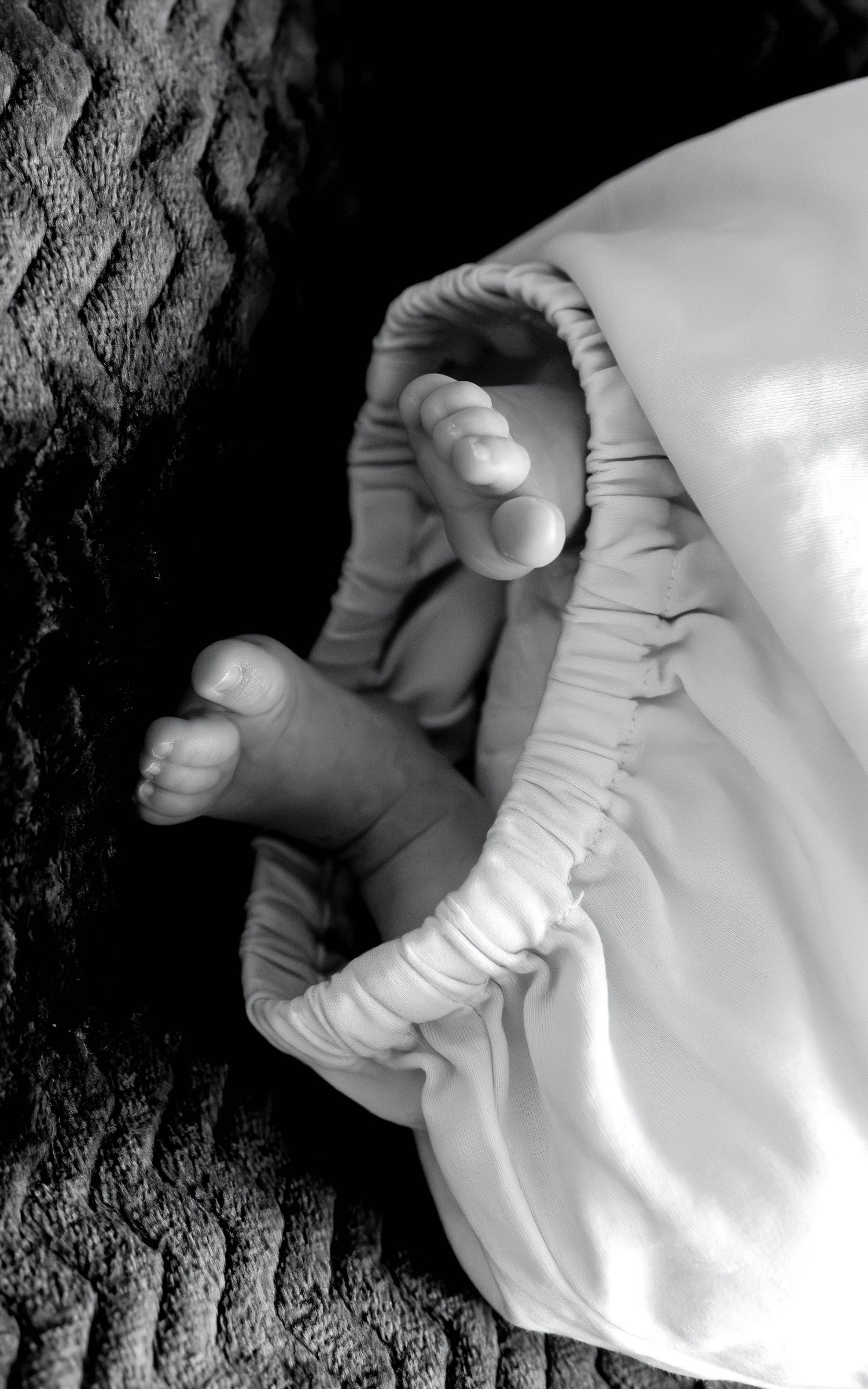 Close-up series of hands wrapping a white bandage or gauze around an injury in black and white.