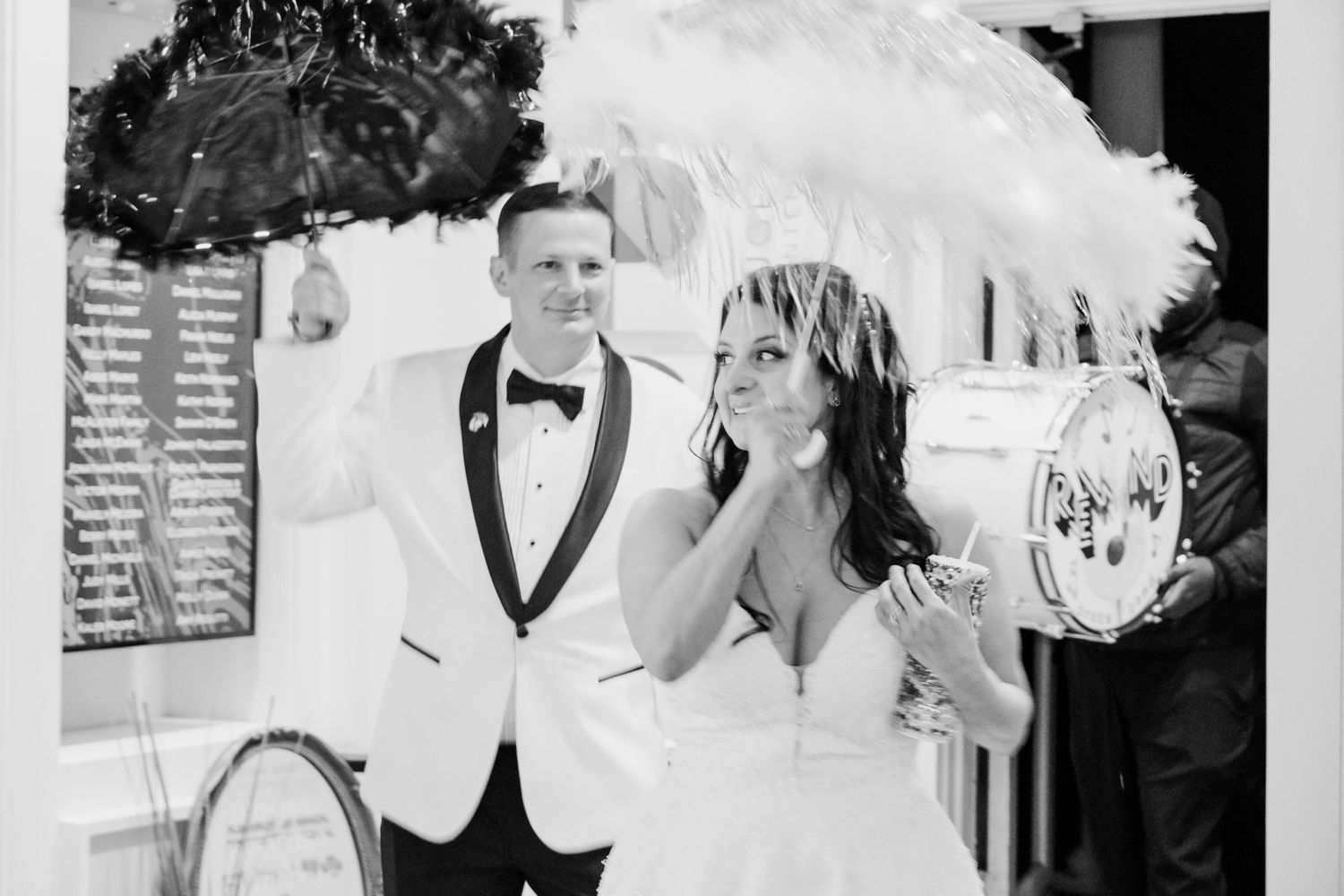 A vintage black and white photo shows a couple at doing a second line at their wedding