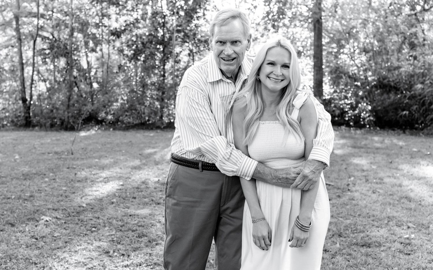 A happy couple poses together outdoors in a series of black and white photographs showing affectionate moments.