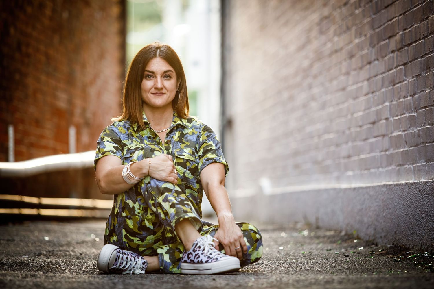 A collage of stylish lifestyle photos showing someone sitting in urban alleyways wearing casual attire.