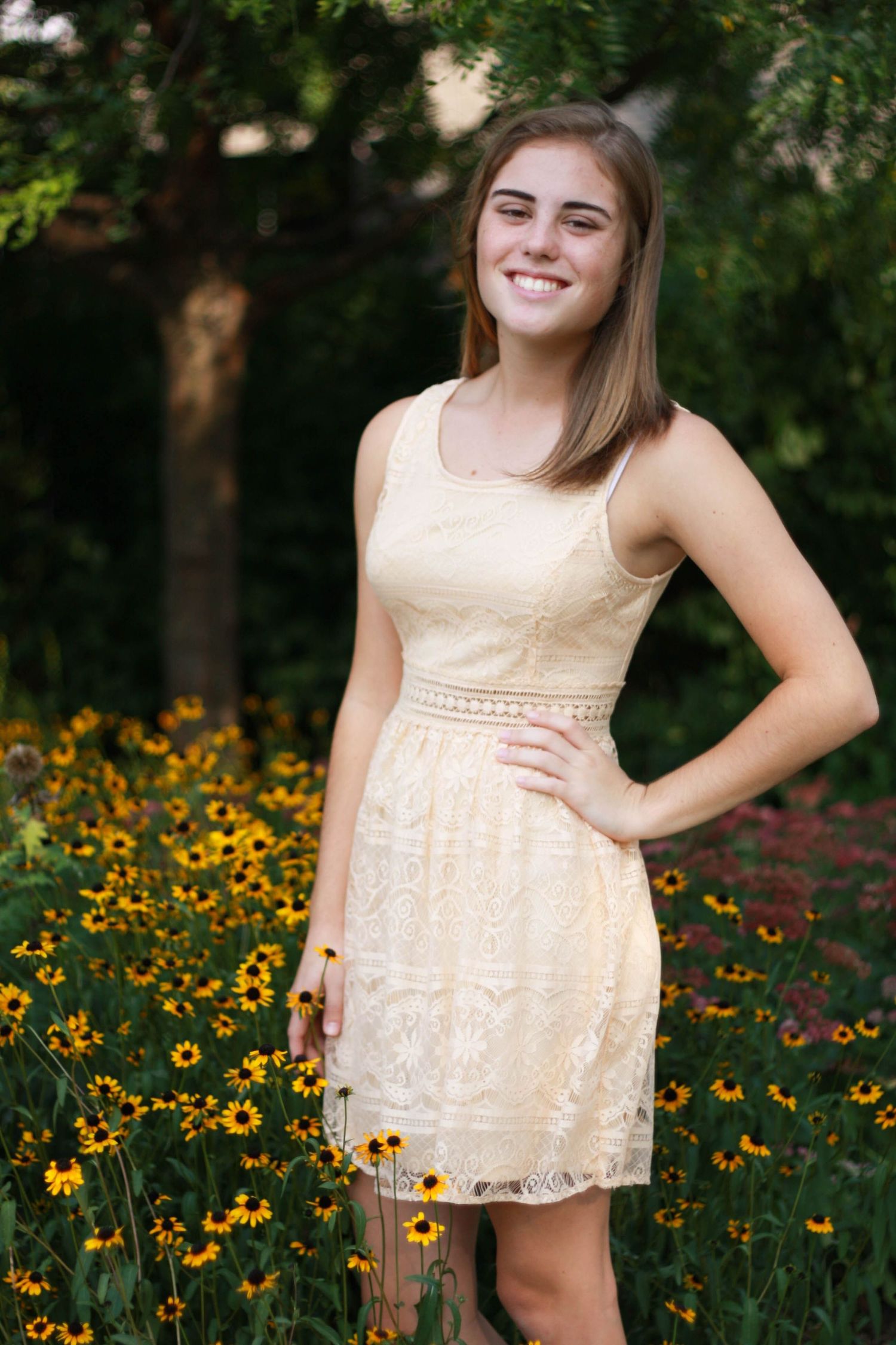 Feminine summer dress photographed in garden with blooming black-eyed susan flowers.