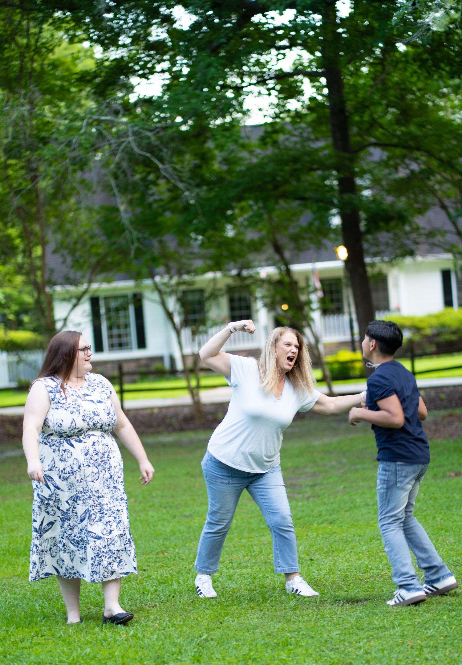 Five sequential photos show two friends having fun performing playful dance moves together on a grassy lawn.