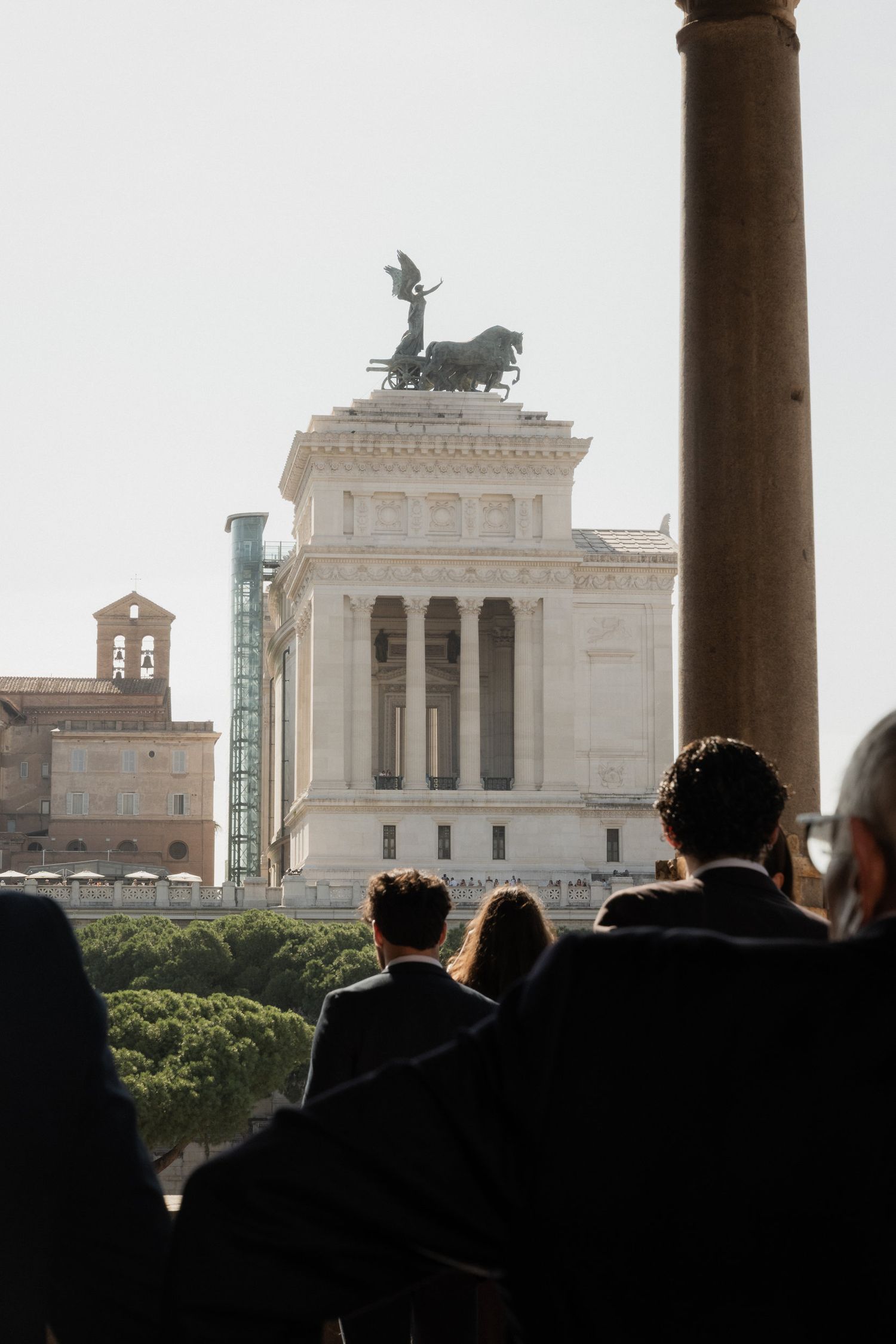 View of the Victor Emmanuel Monument in Rome through stone columns.