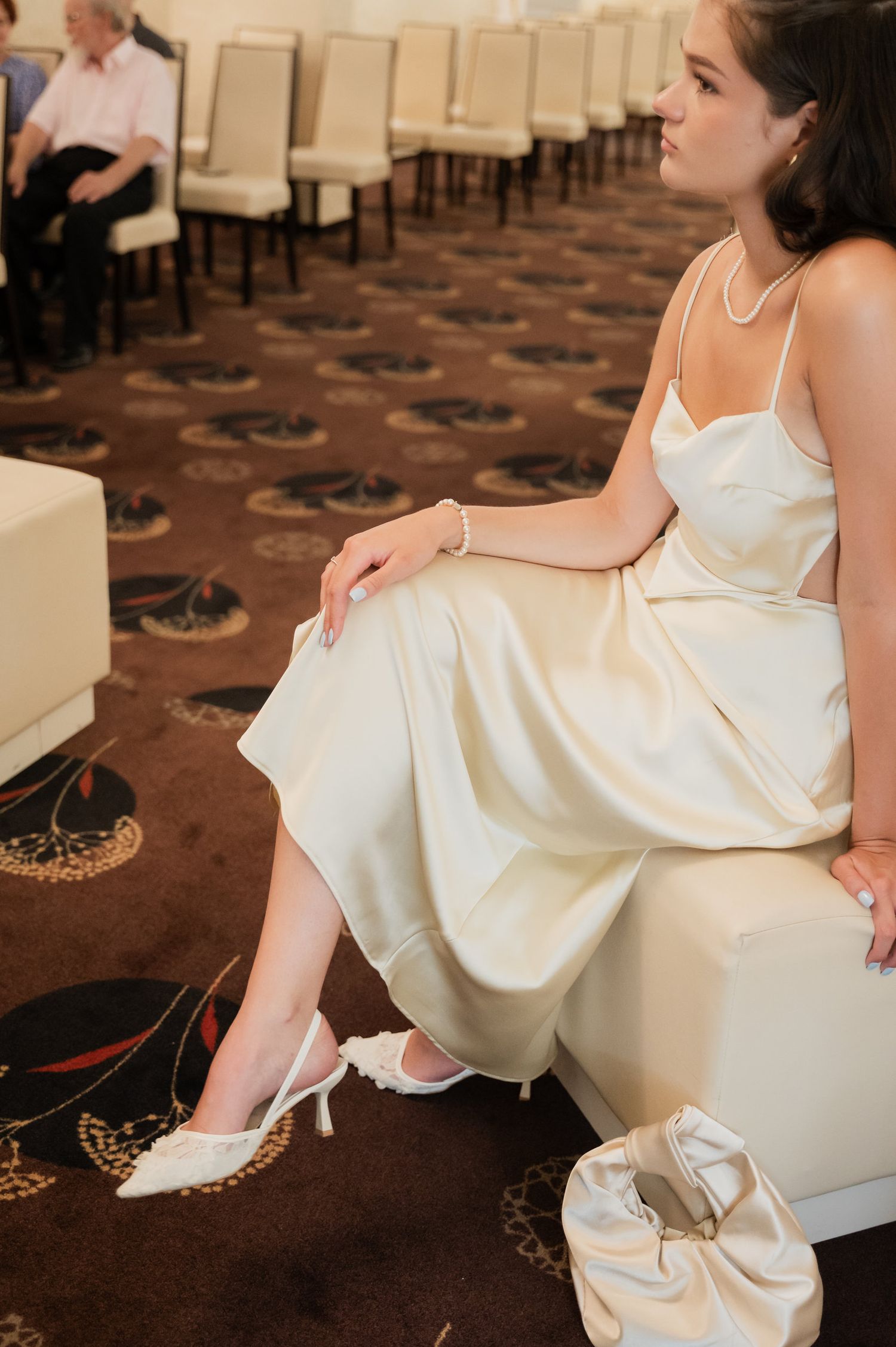 Elegant bridal portraits featuring a white satin dress and delicate shoes.