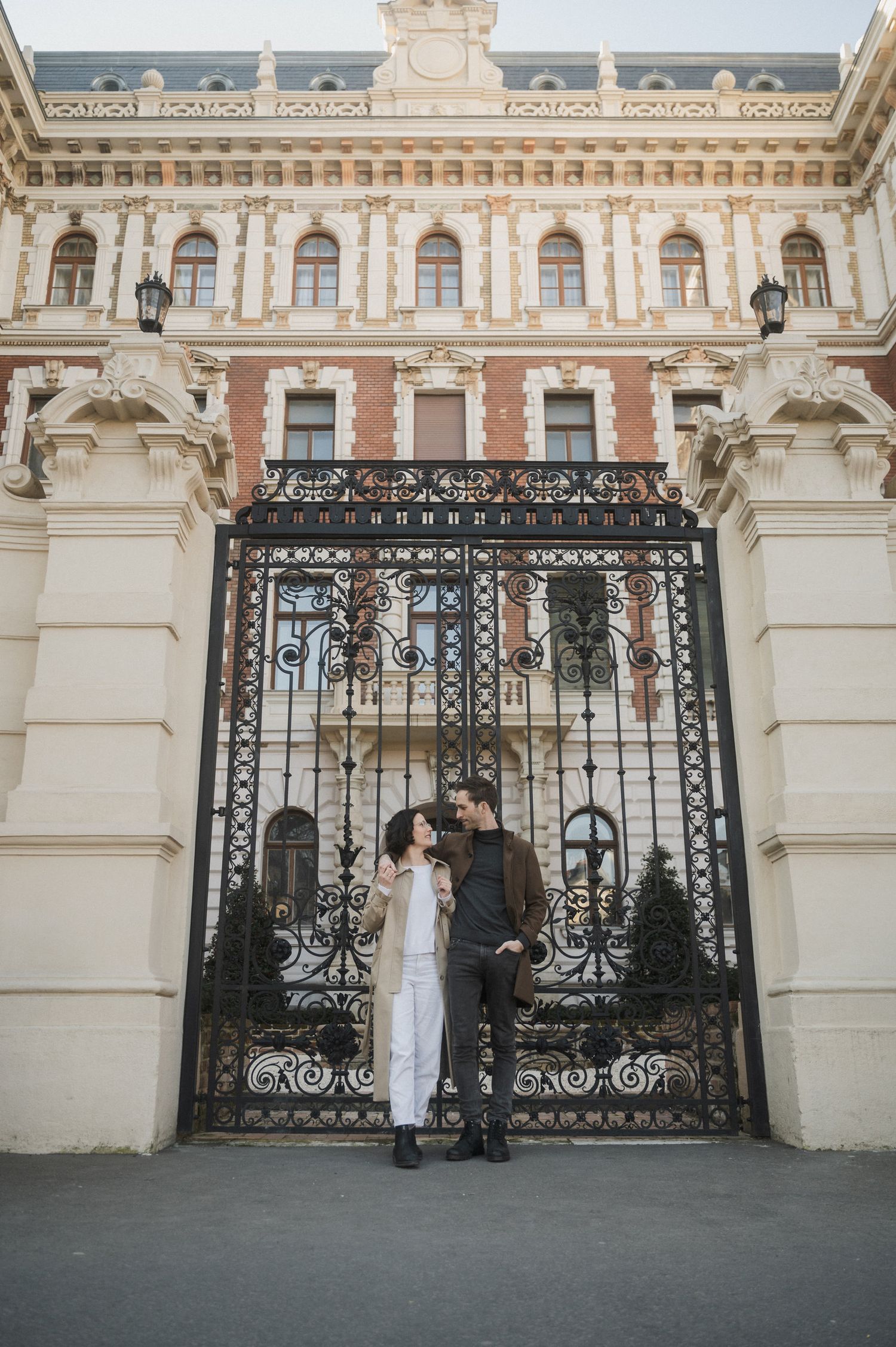 Elegant wrought iron gates against ornate classical architecture at Belvedere Palace in Vienna create a dramatic backdrop.