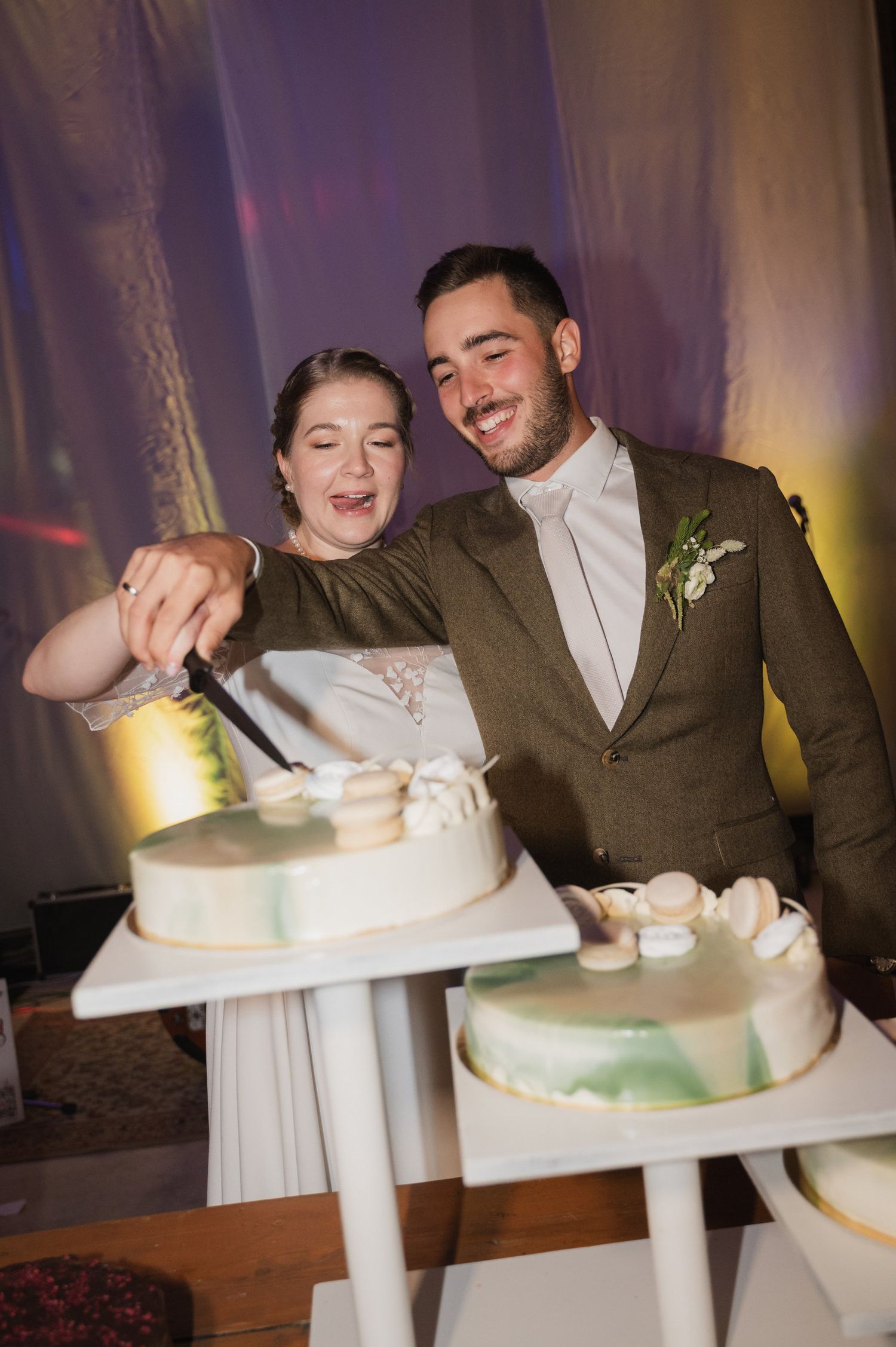 A couple cutting their white wedding cake together in a sequence of progressive shots showing the traditional cake cutting moment.