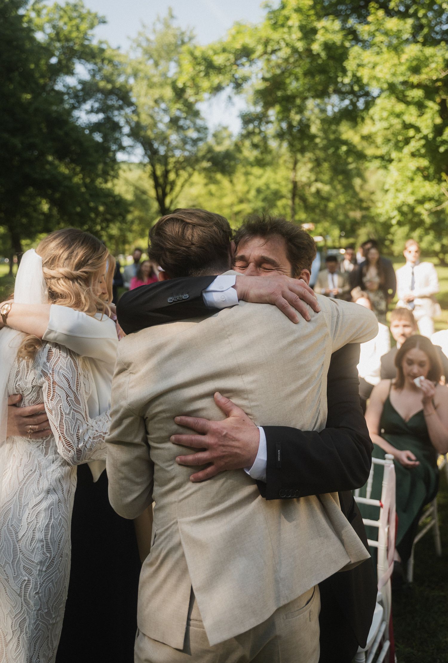 A sequence of photos showing people embracing in an outdoor setting with green trees in the background.