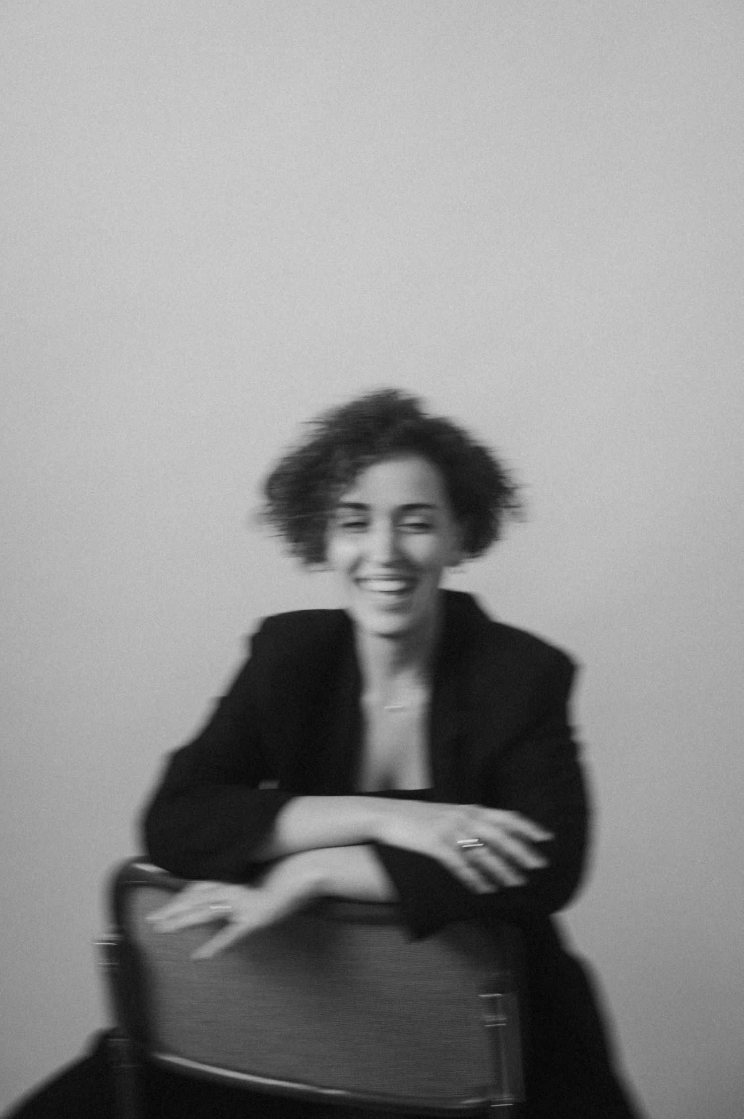 Expressive black and white portraits showing movement and laughter in a studio setting.
