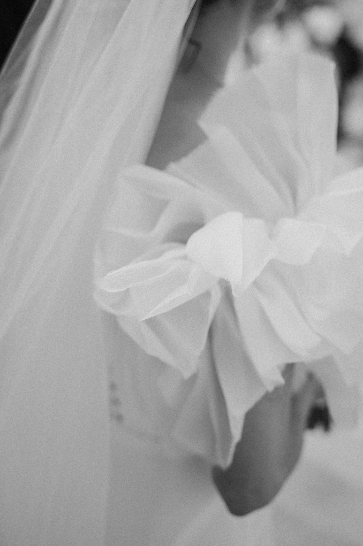 Soft focus detail of white fabric or veil with delicate texture.
