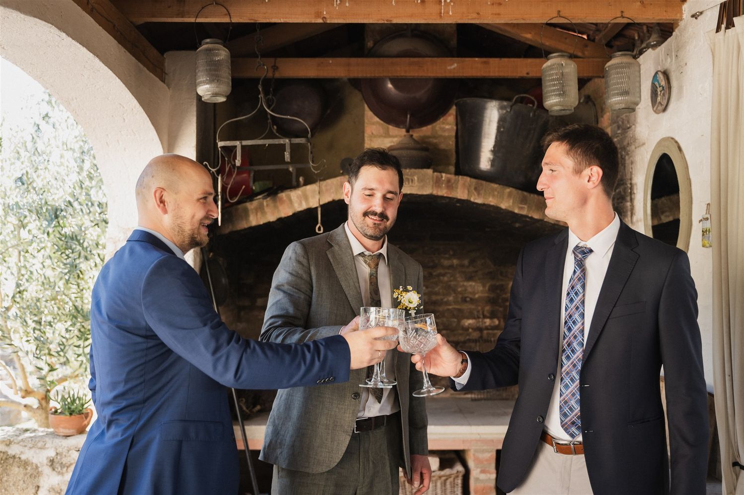 Guests socializing in a rustic indoor venue with wooden beams and brick walls.
