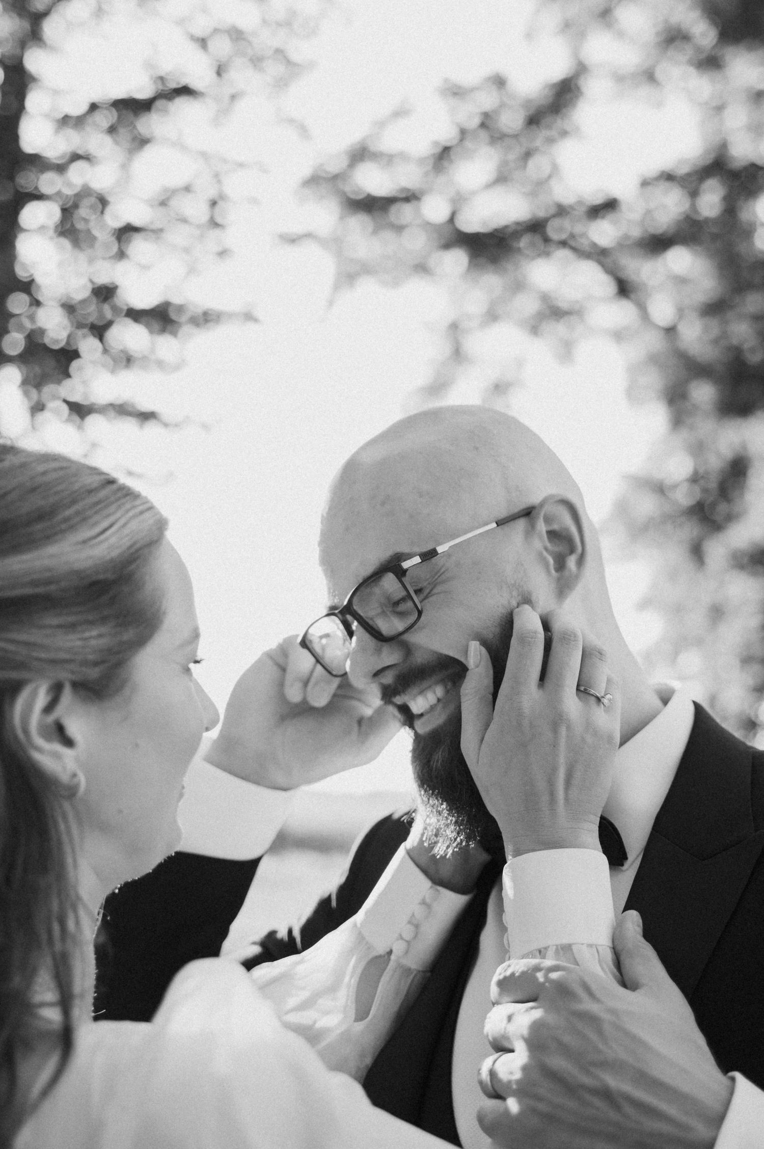 Black and white romantic photo sequence showing a couple kissing from multiple angles in an outdoor setting.