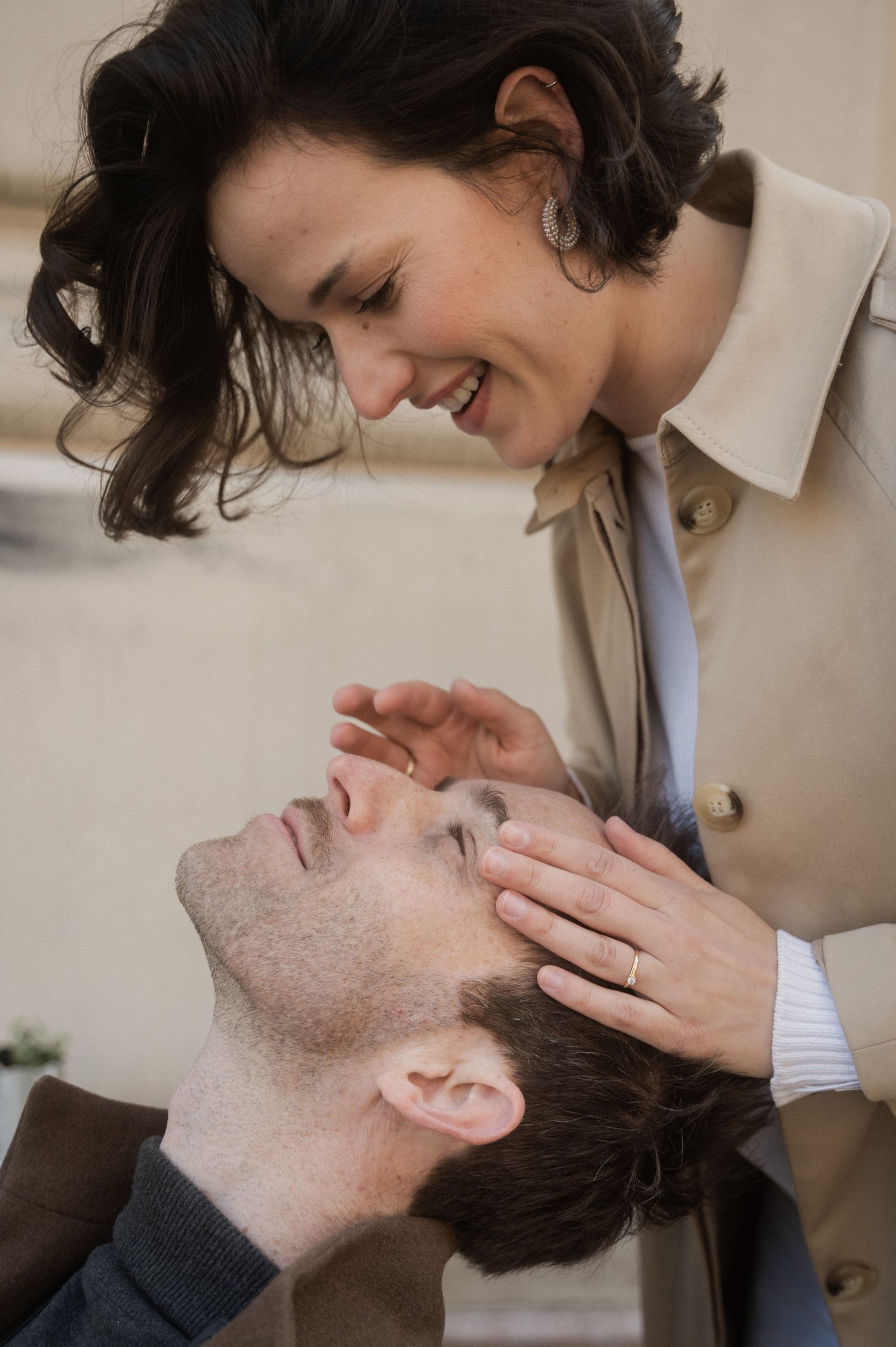 A romantic couple sharing tender intimate moments in a series of close-up shots against a neutral background.