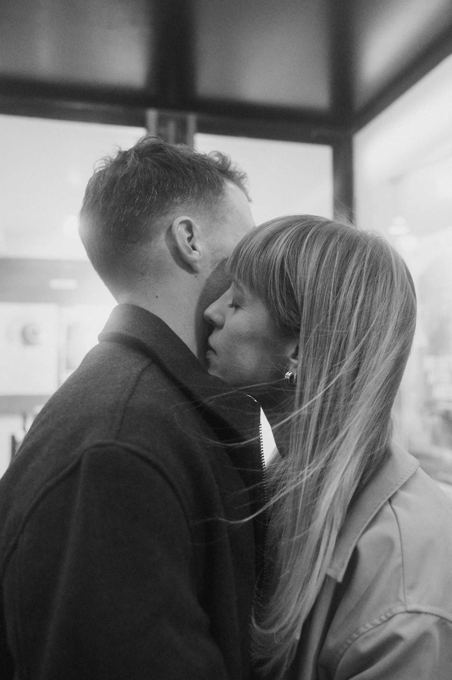 Black and white photo series showing a romantic couple in profile sharing intimate moments and kisses.