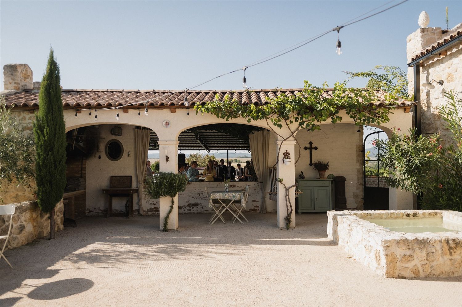 Rustic stone venue with string lights and Mediterranean architectural details.