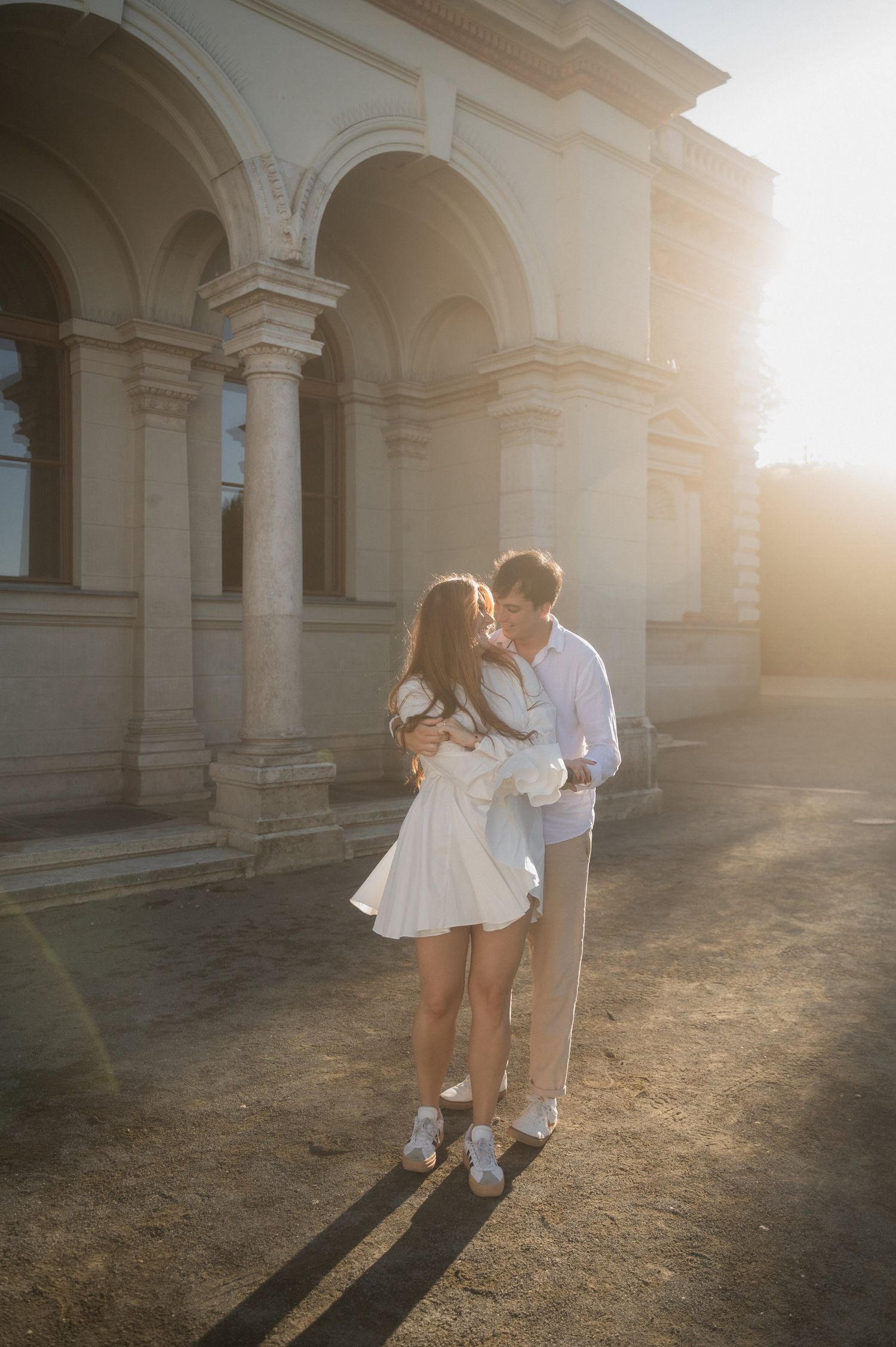 Romantic sunset portraits under beautiful arched colonnade.
