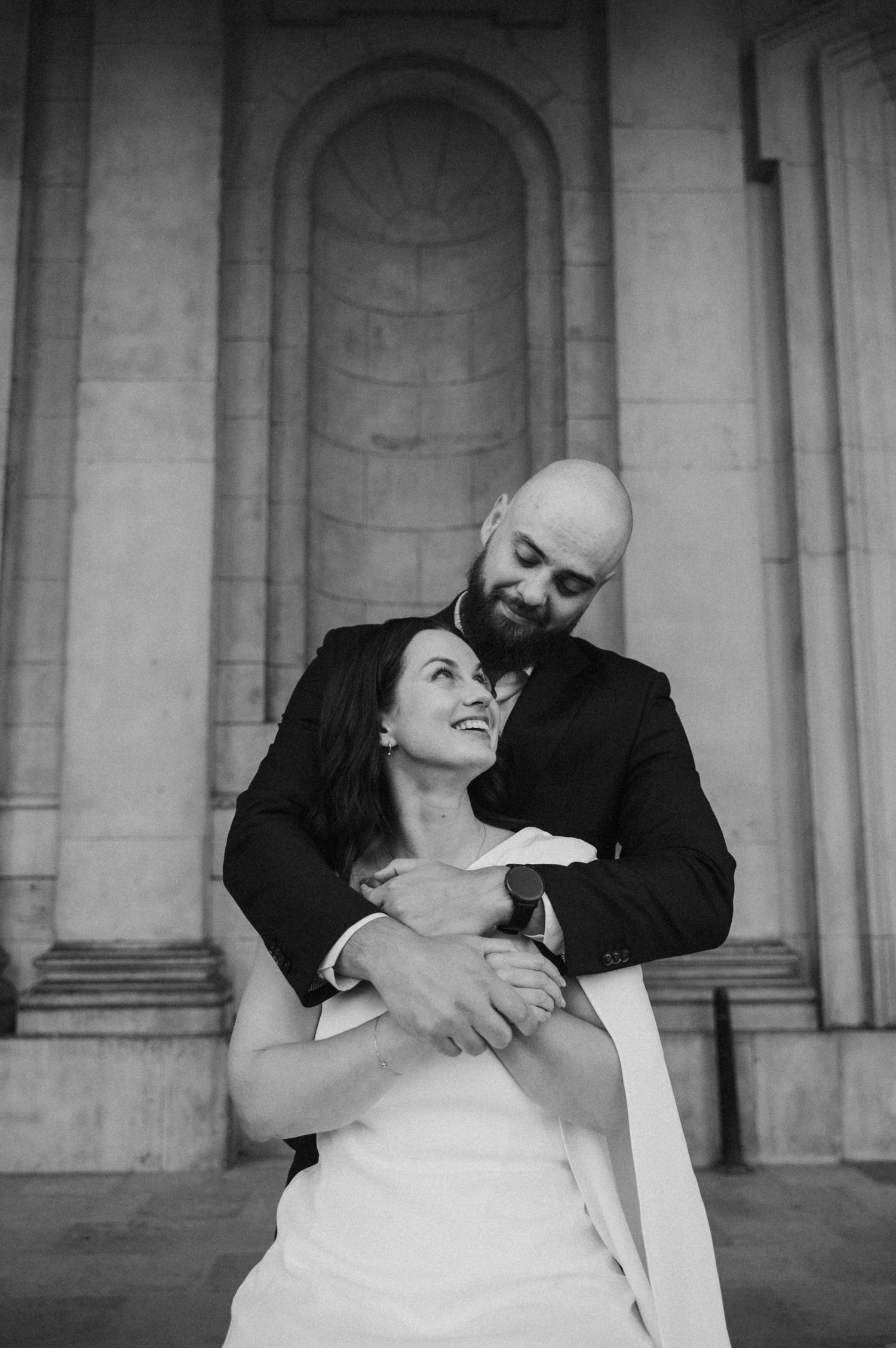 Expressive black and white wedding portraits showing natural laughter and connection.