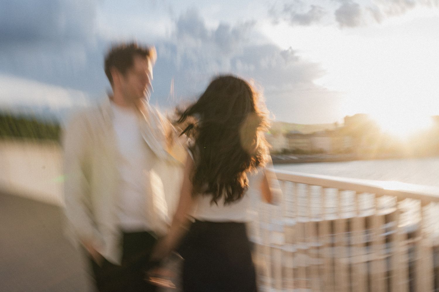Blurred romantic silhouettes dancing against a sunset sky.