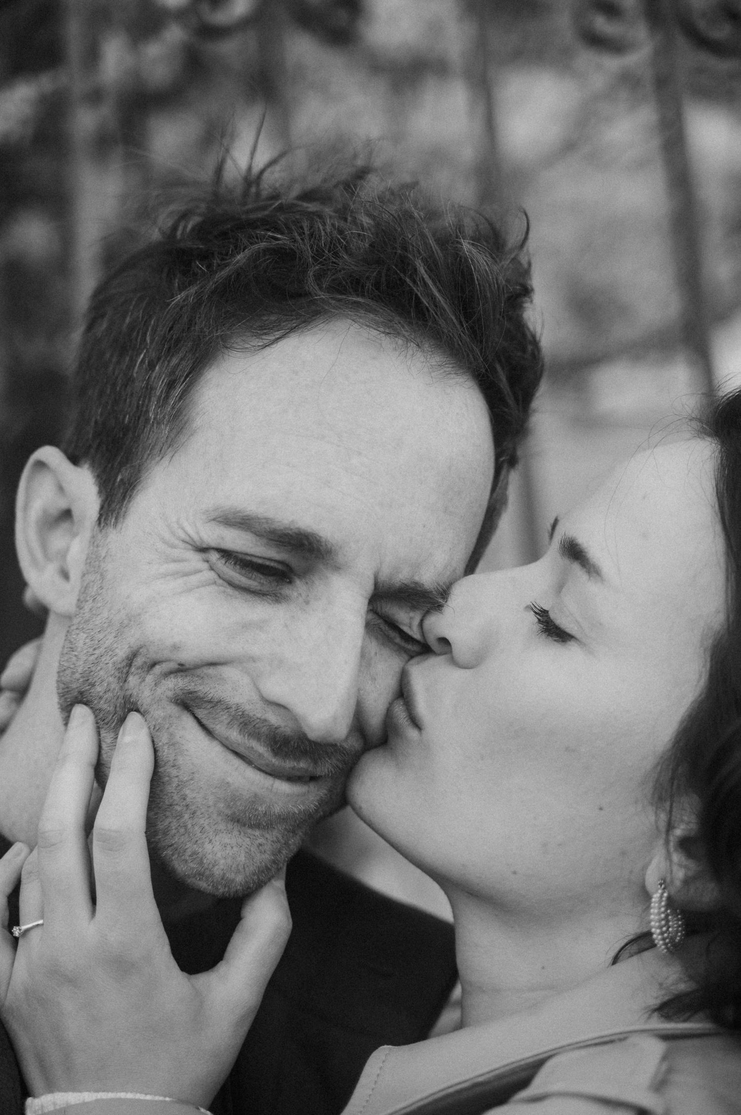 A romantic black and white photo series showing tender moments between a couple in close embrace.