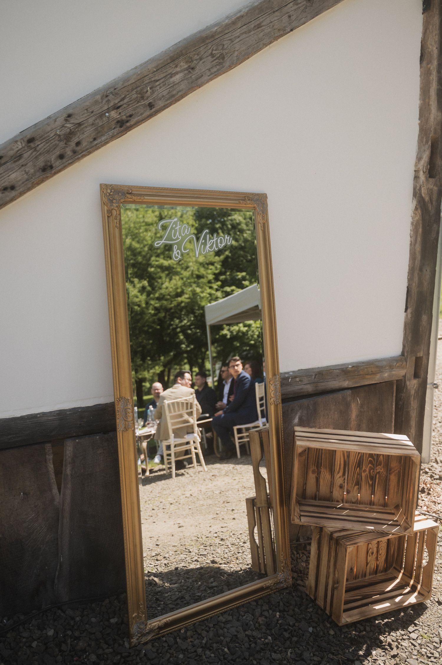 A series of wooden doorway frames showing a rustic outdoor setting with gravel and trees in the background.