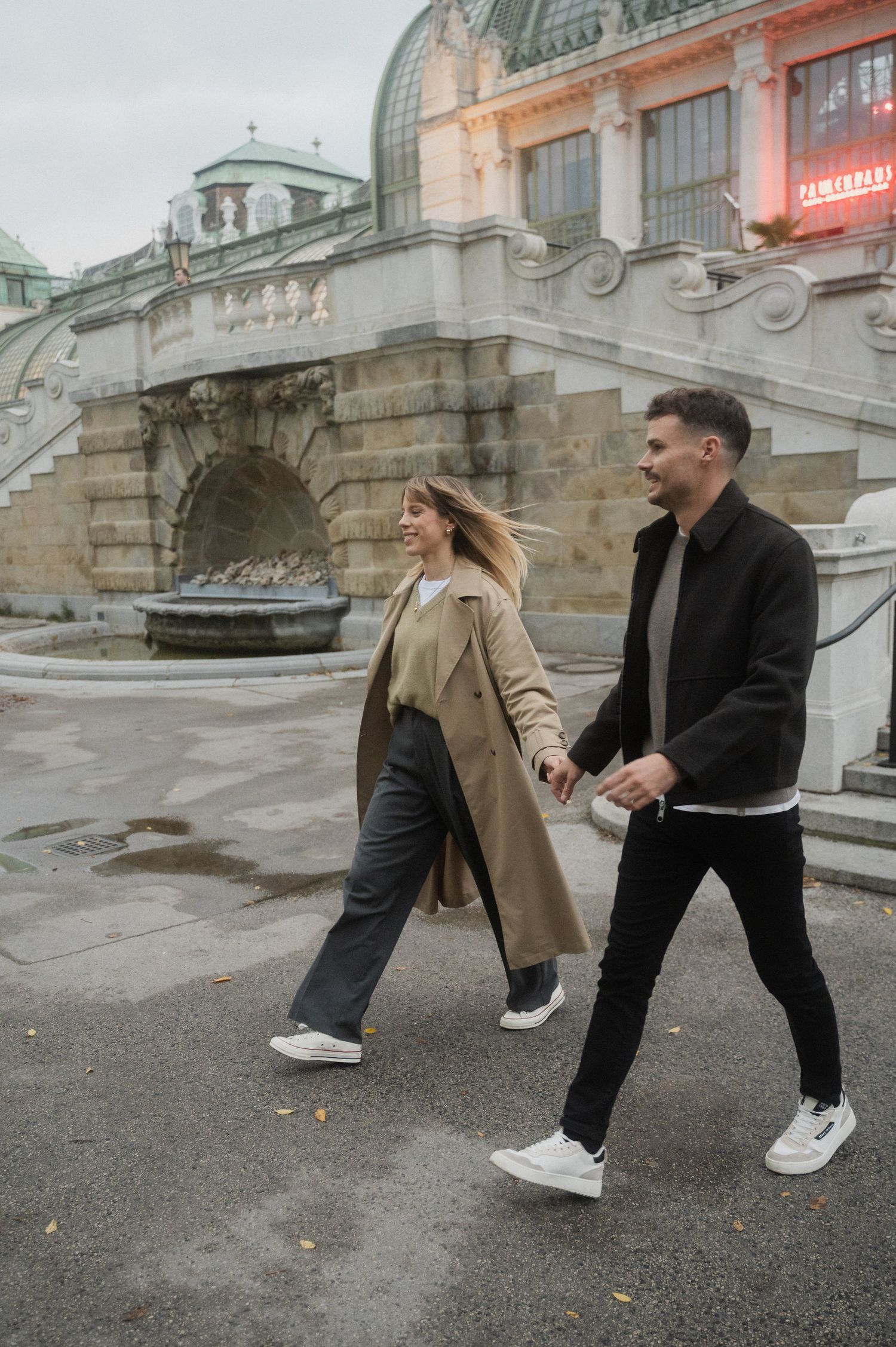 A sequence of photos showing two people in casual wear performing dance-like movements on a city street.