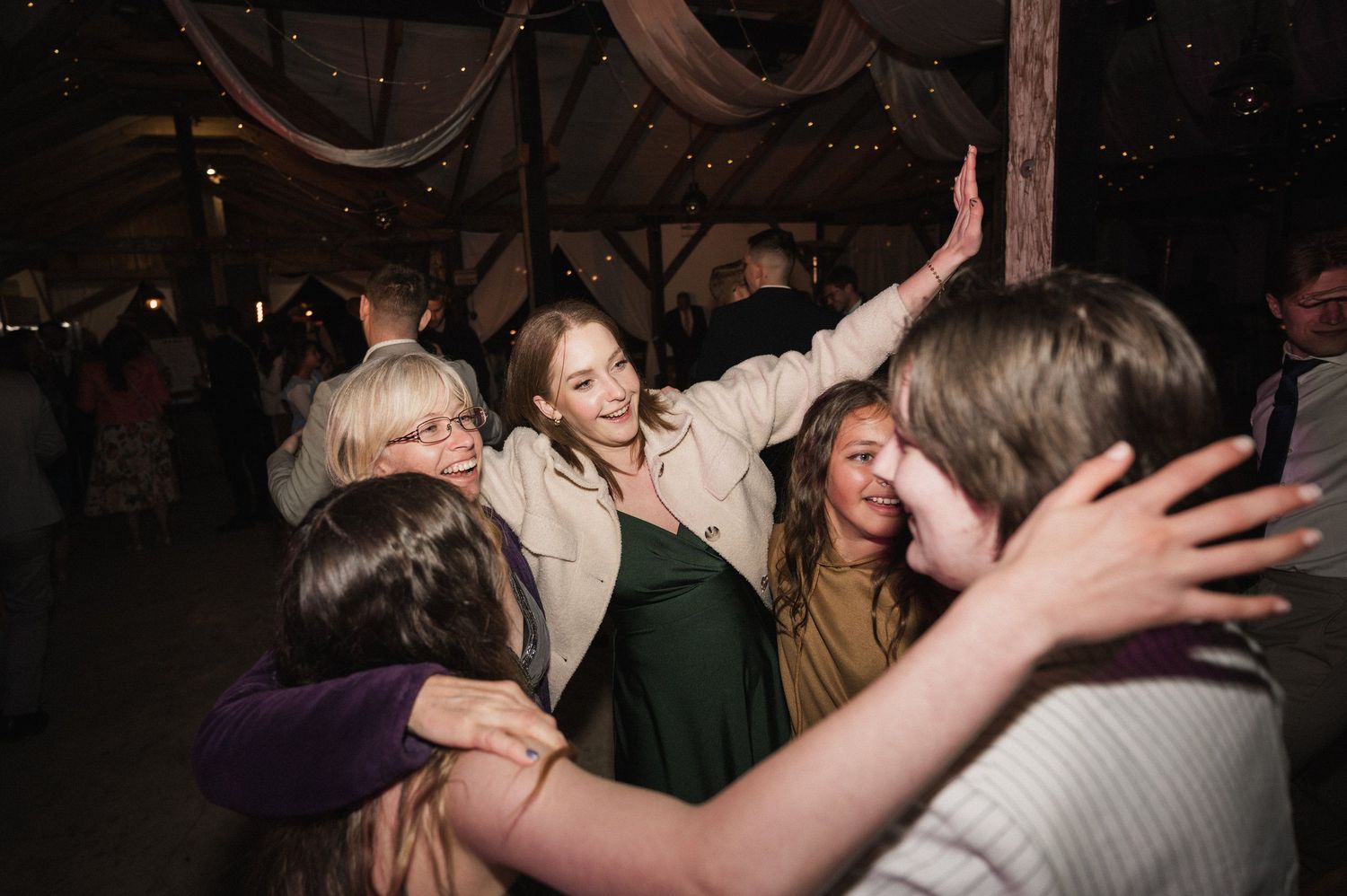 People dancing close together in a dimly lit venue with blurred motion creating an energetic party atmosphere.