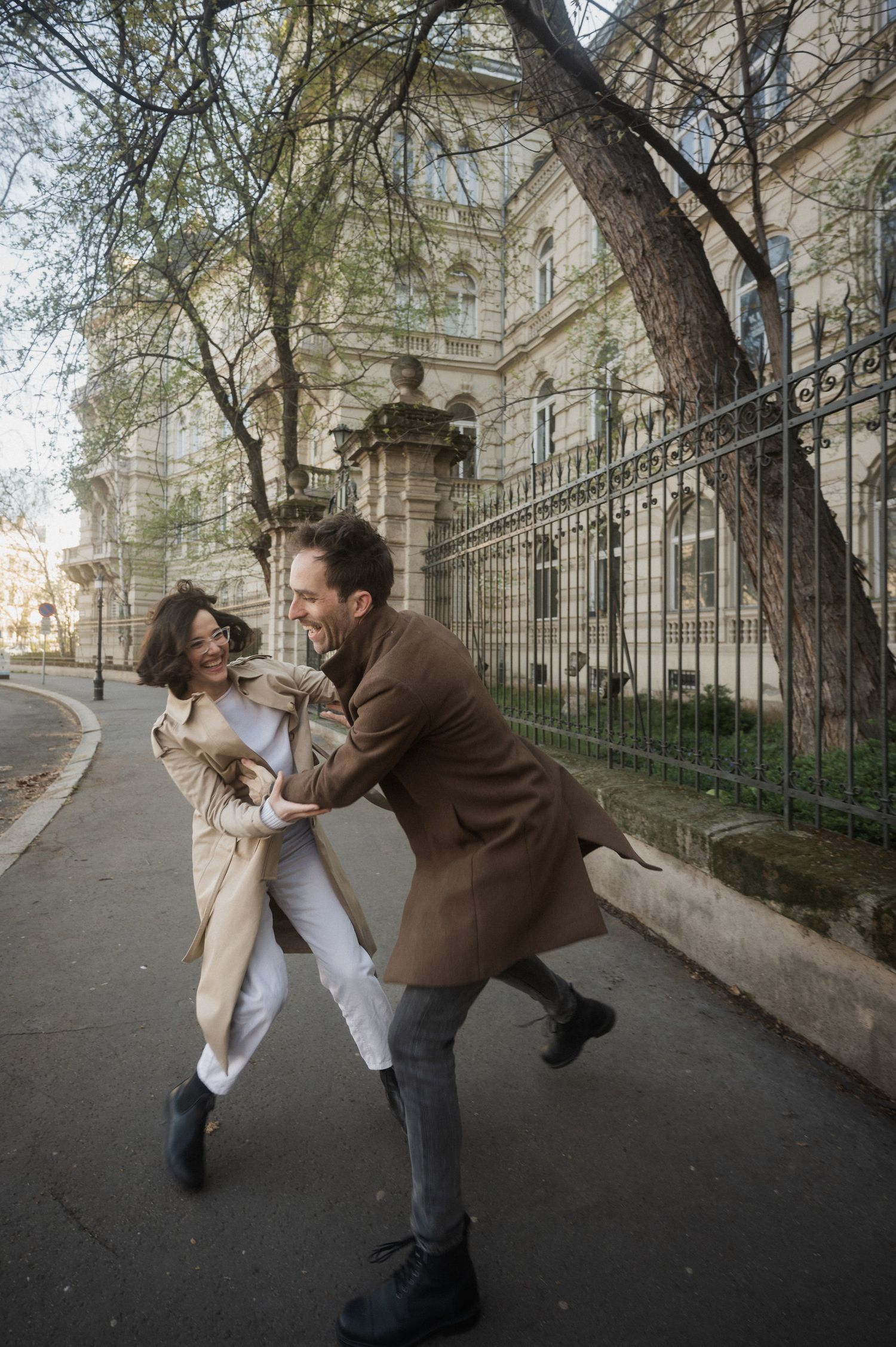 A playful sequence of a couple dancing and leaning back dramatically on a city street.