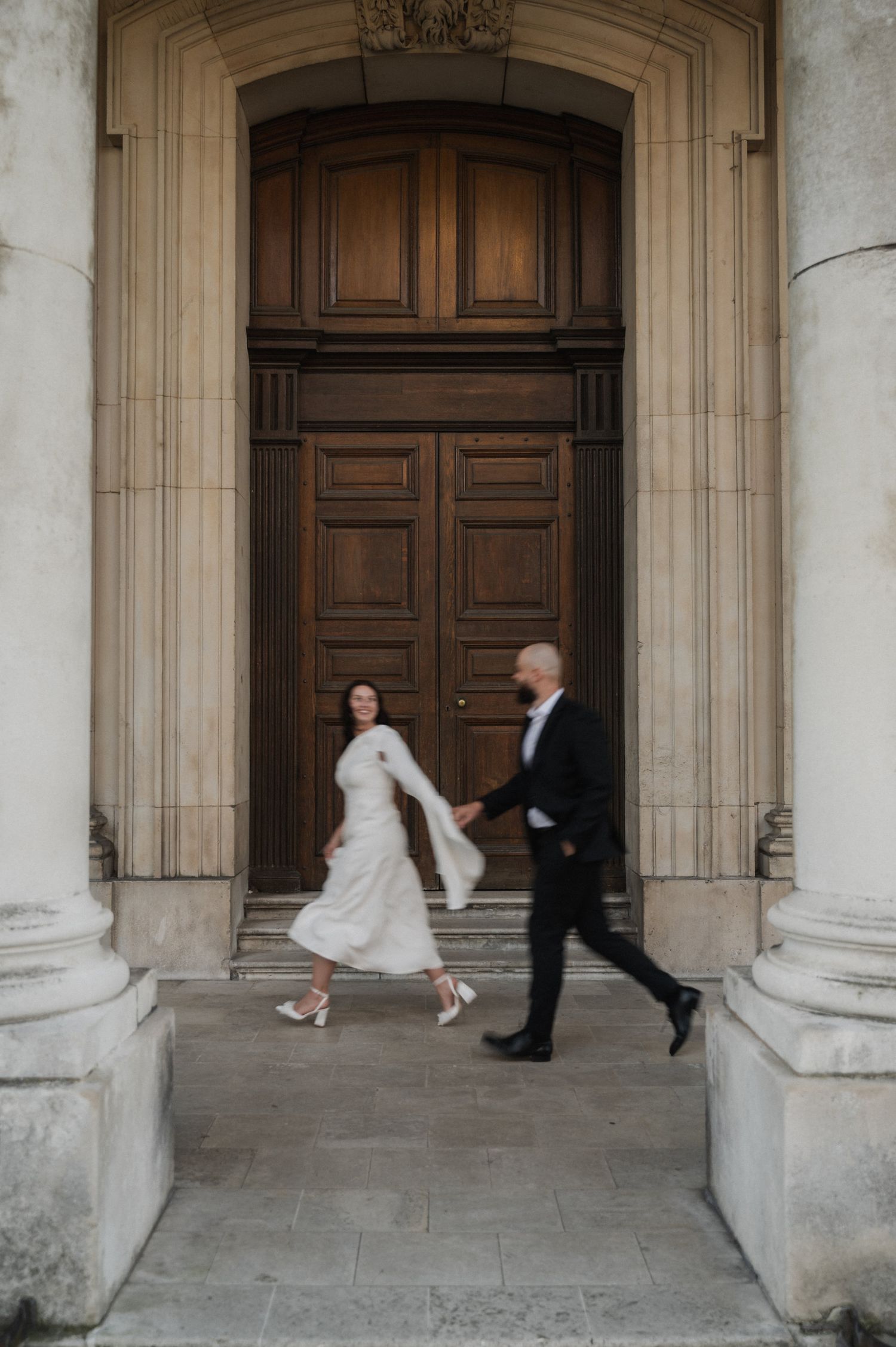 Artistic wedding sequence showing flowing movement against classical building facade.