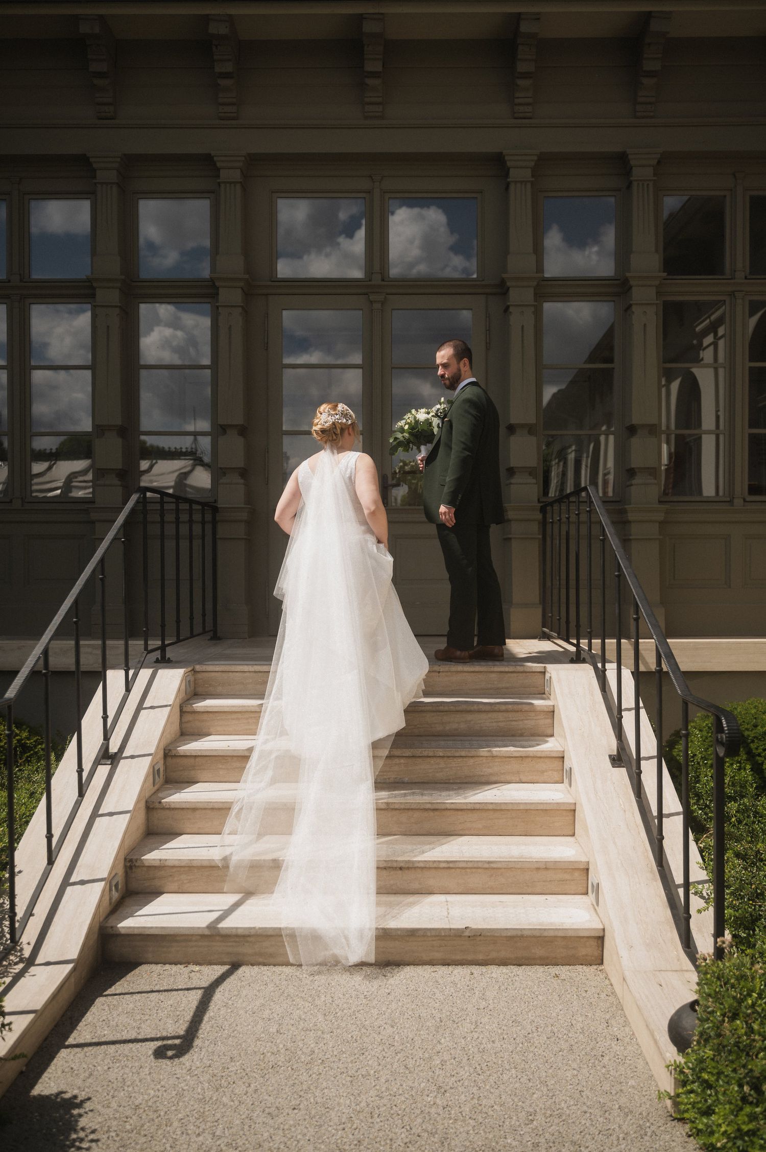 A wedding ceremony moment captured on stone steps of a historic building.