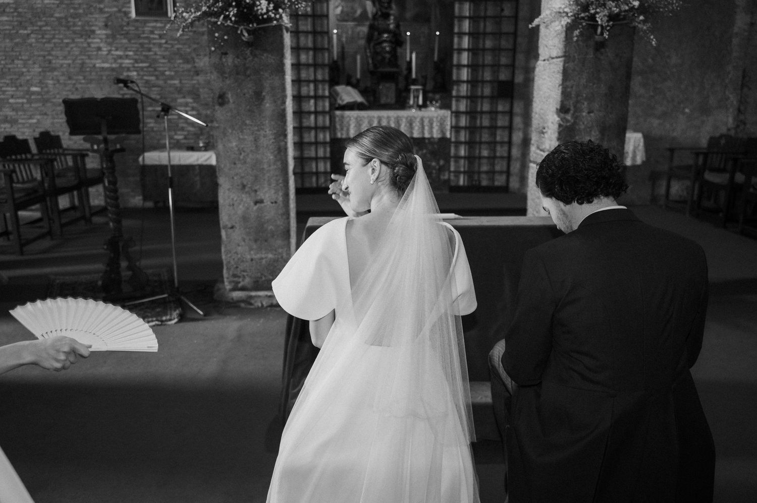 Black and white photo sequence of a wedding ceremony in a historic stone church interior.