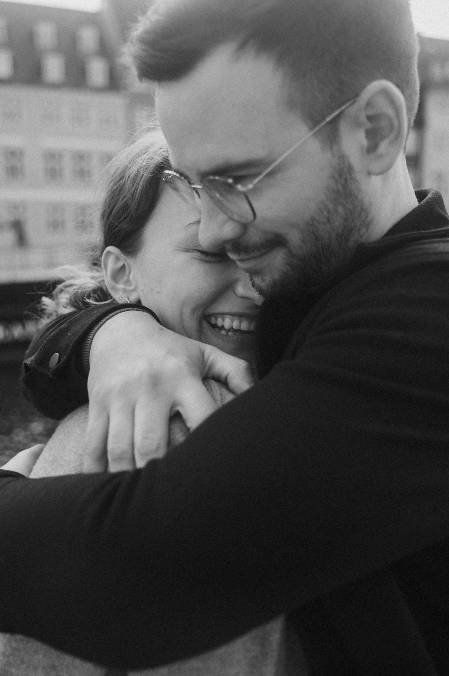Intimate black and white portrait of a couple sharing tender moments together.