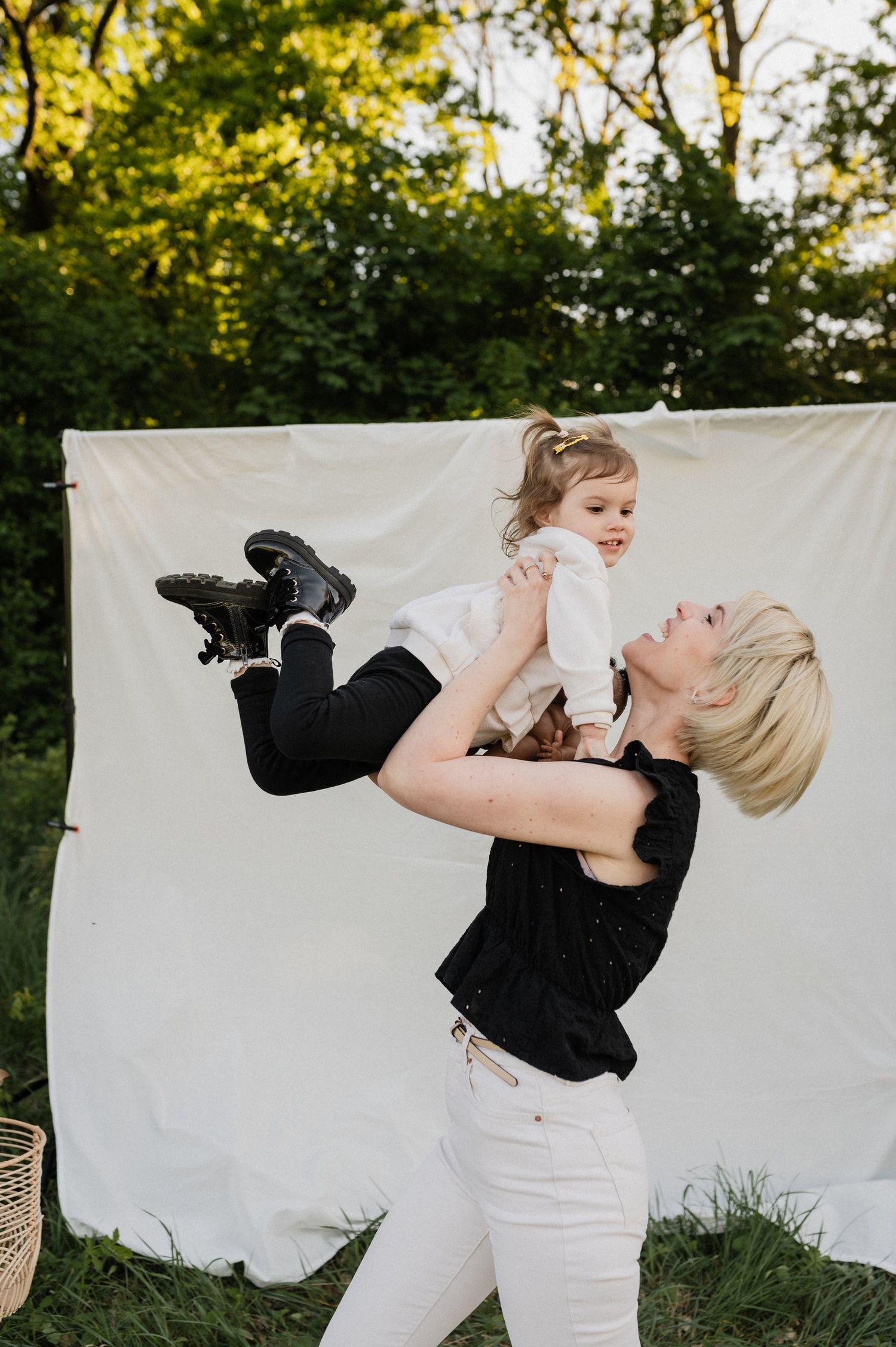 A series of photos showing joyful moments captured against a white backdrop outdoors in natural lighting.