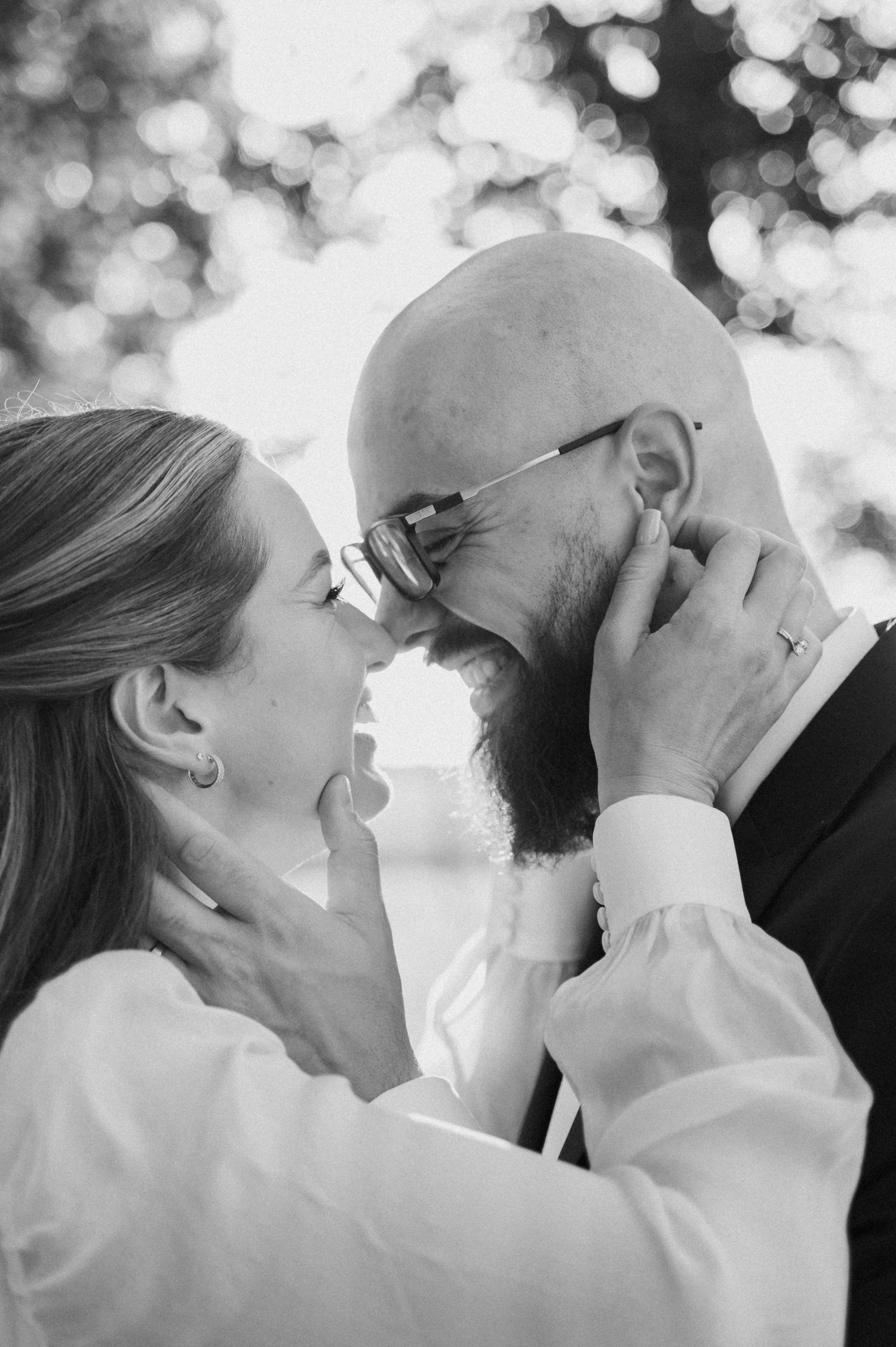 A romantic black and white photo sequence showing a couple sharing tender kisses with soft bokeh lighting in the background.