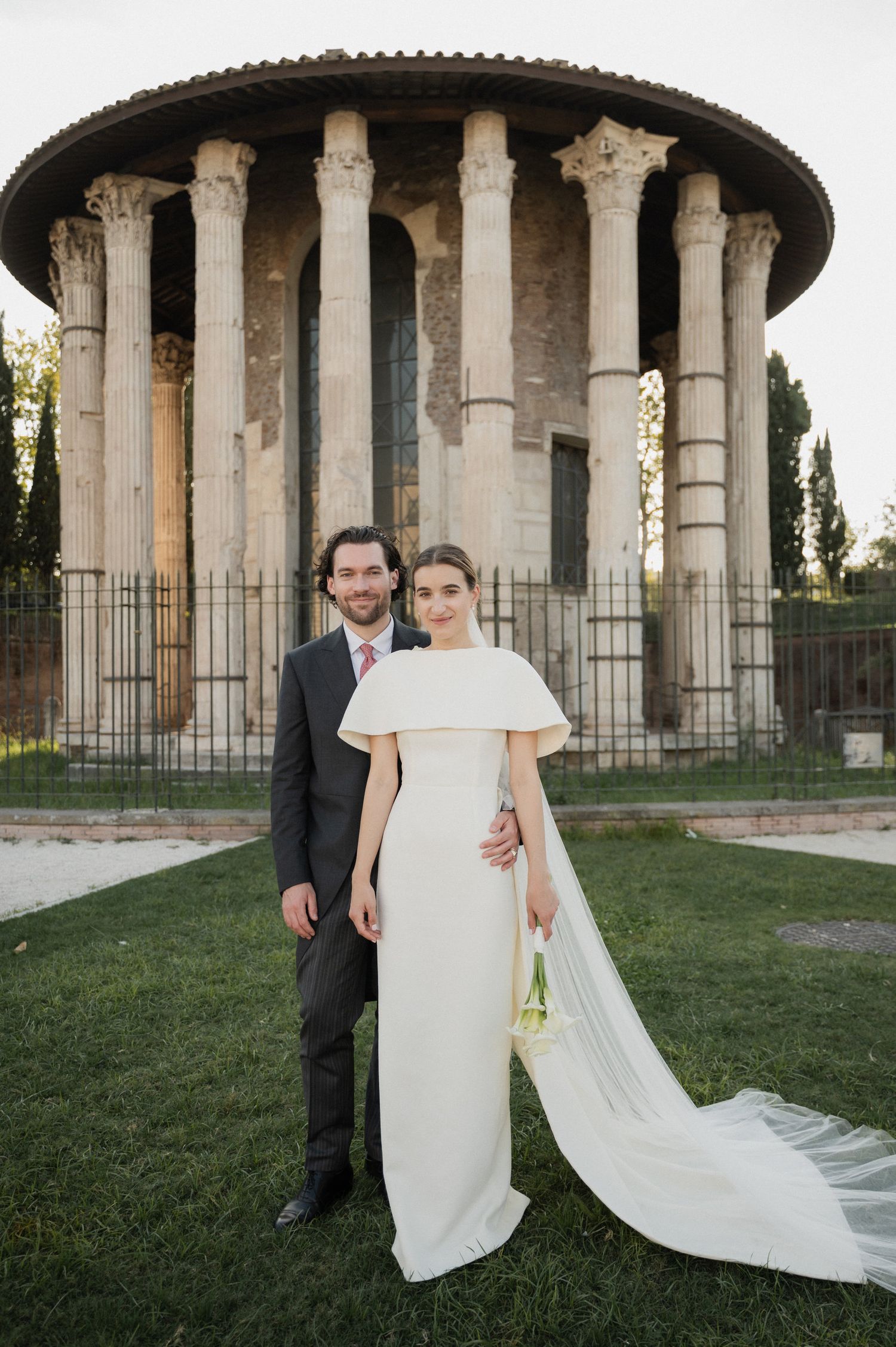 Wedding photo session at a classical columned temple with flowing white dress and veil.