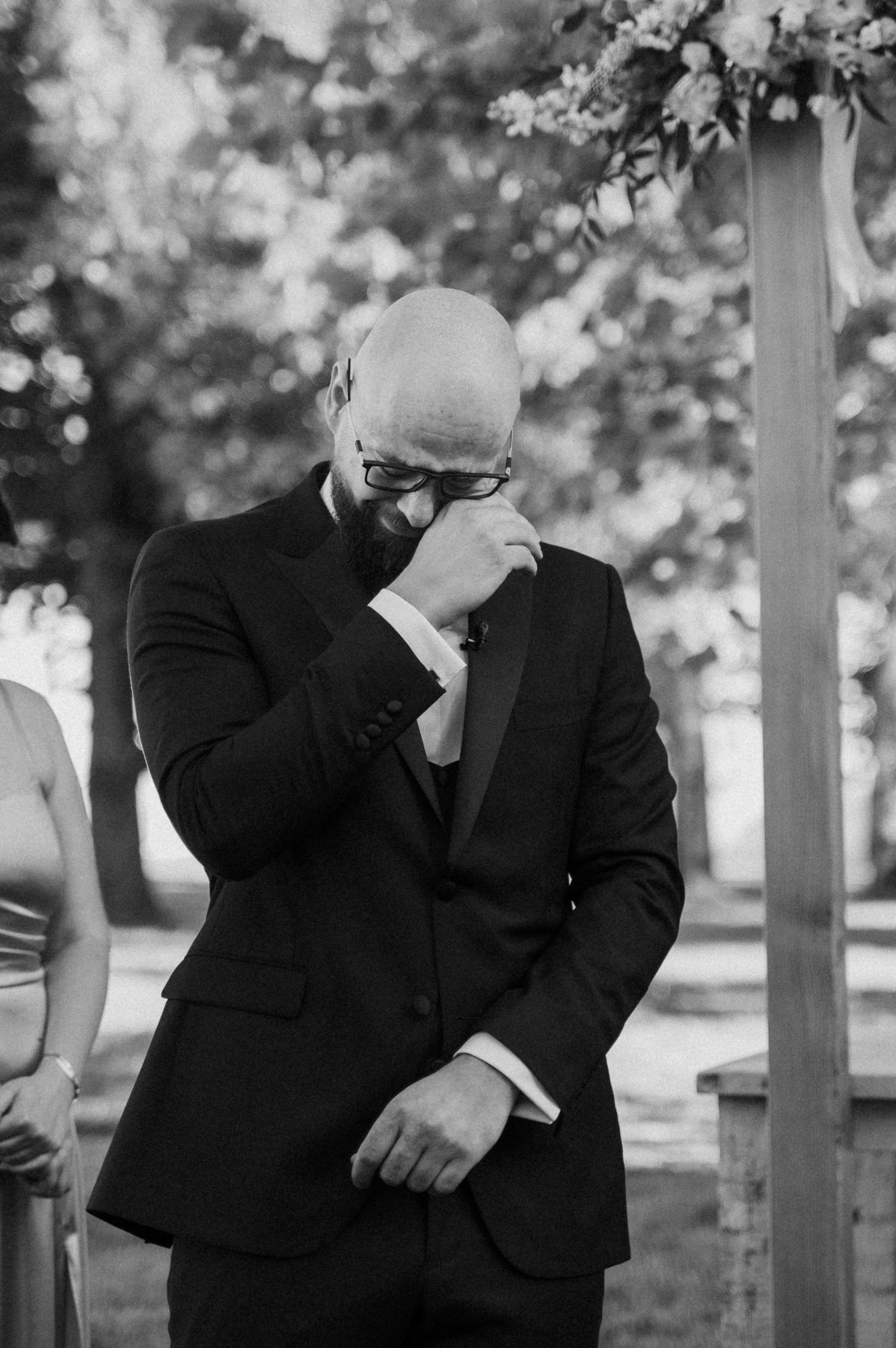 Black and white photo series showing emotional reactions and laughter between people in formal attire outdoors.