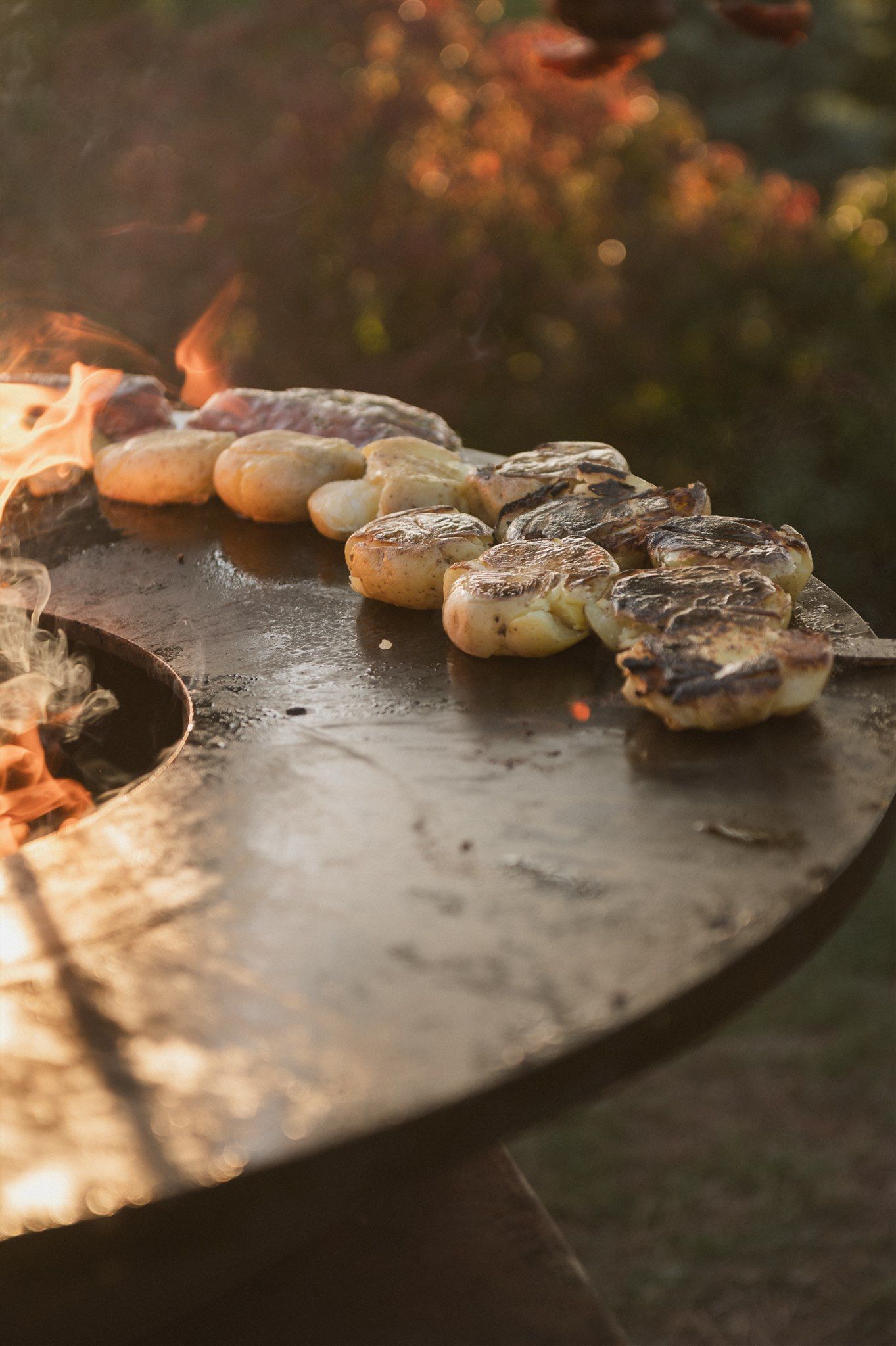 Artisanal bread loaves arranged on a dark surface in warm lighting.