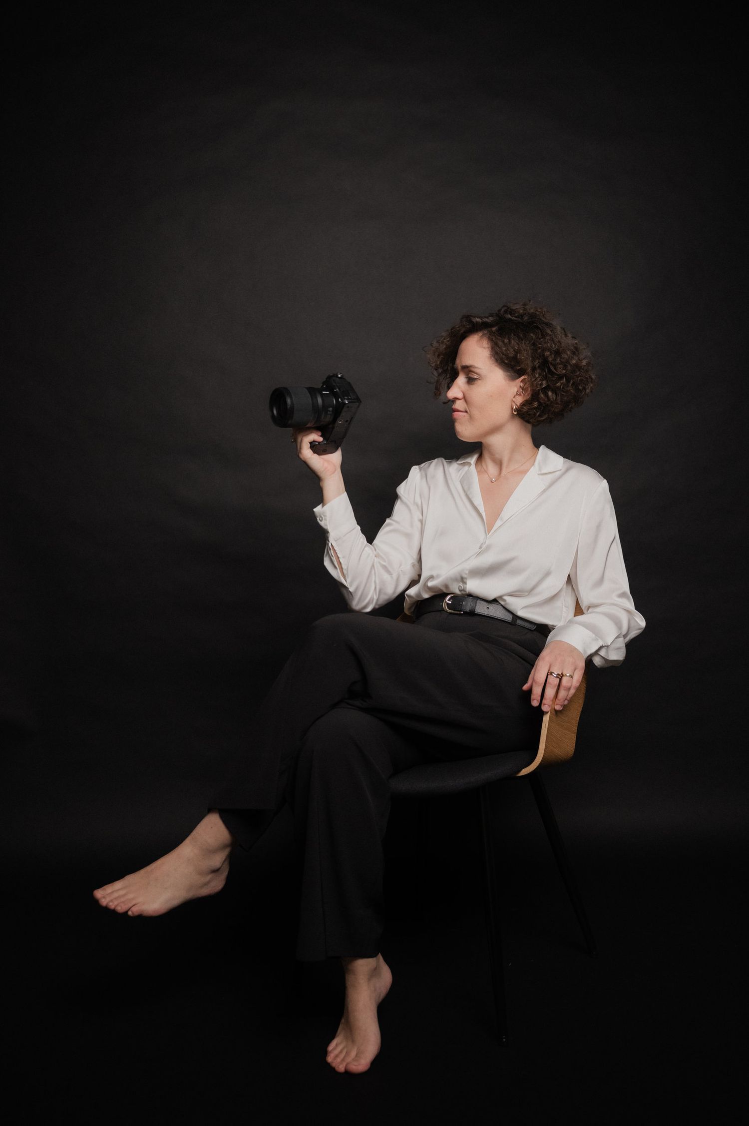A dramatic series of black and white photos showing a figure in a white shirt and dark pants against a dark background.