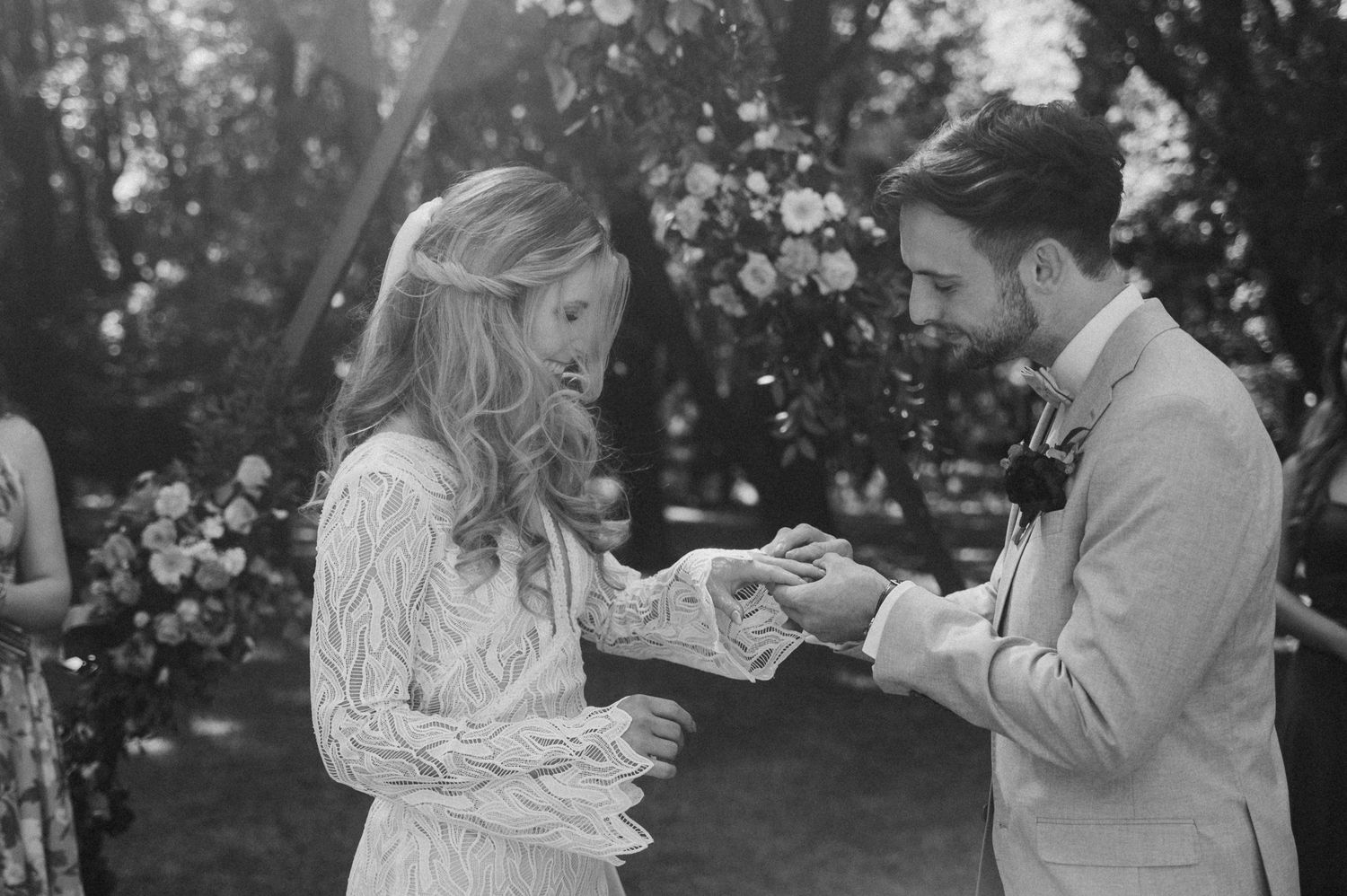 A couple shares an intimate moment together in a garden setting during a romantic photoshoot.